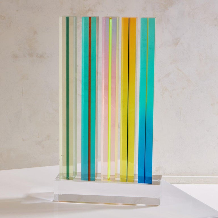 An acrylic sculpture created by Yugoslavian-American artist Vasa Velizar Mihich (b.1933) in 1971. This sculpture is composed of five interchangeable acrylic columns which sit freely on a clear rectangular acrylic base. The columns were cast in a