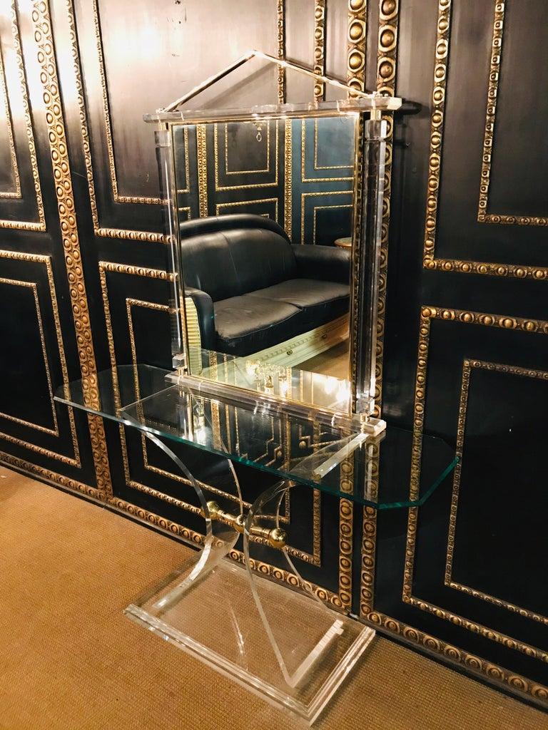Acrylic console with brass in an unusual design with mirror high quality.
The mirror has angular pillars on the right and left side.
Made in Italy.