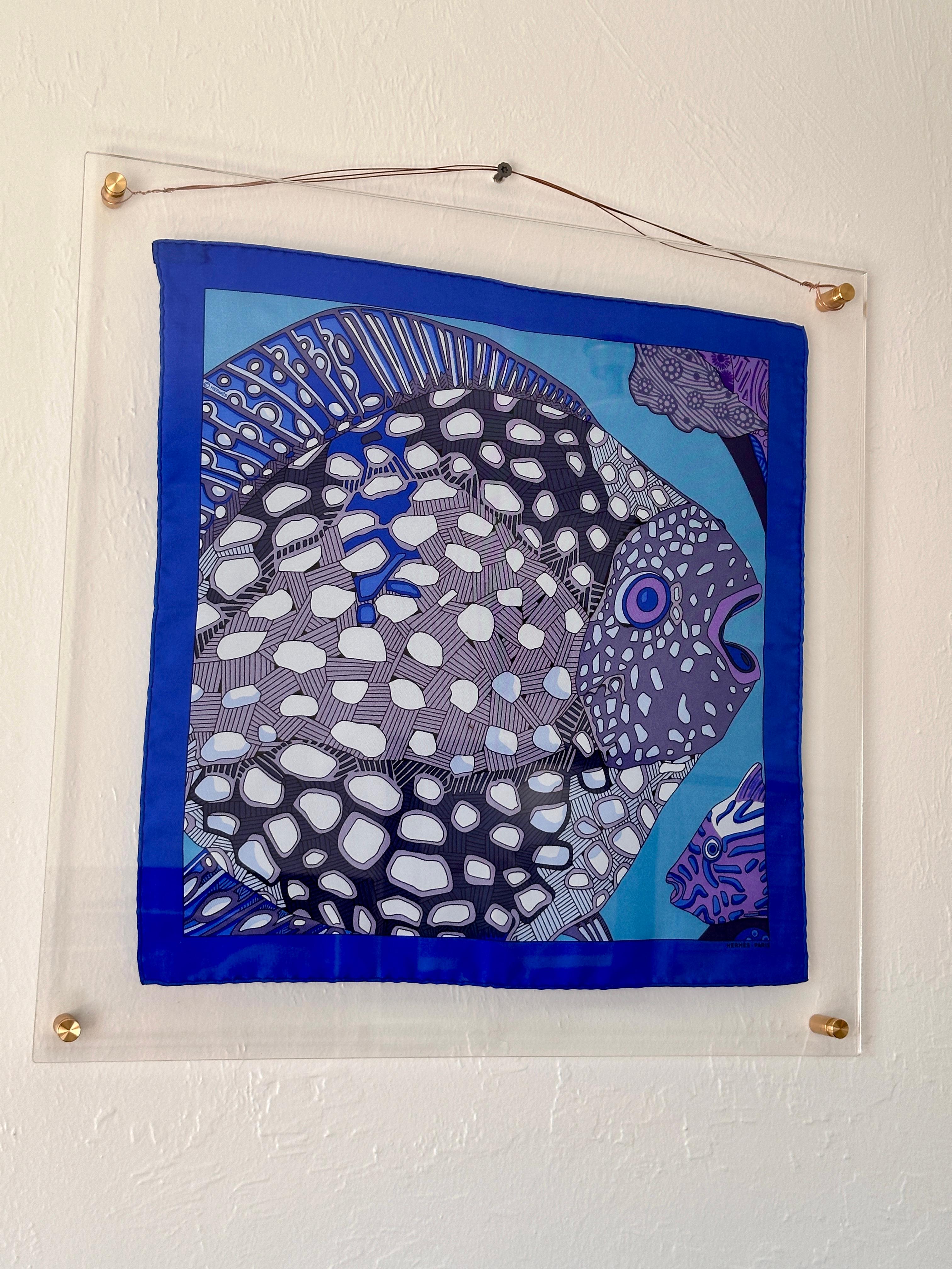 A coveted collector’s item, this Hermès ‘Grands Fonds’ Blue (Detail) Silk Scarf features an intricate aquatic design by the renowned artist Annie Faivre.
Originally designed in 1992, this rare version focusing on a detail from the original pattern
