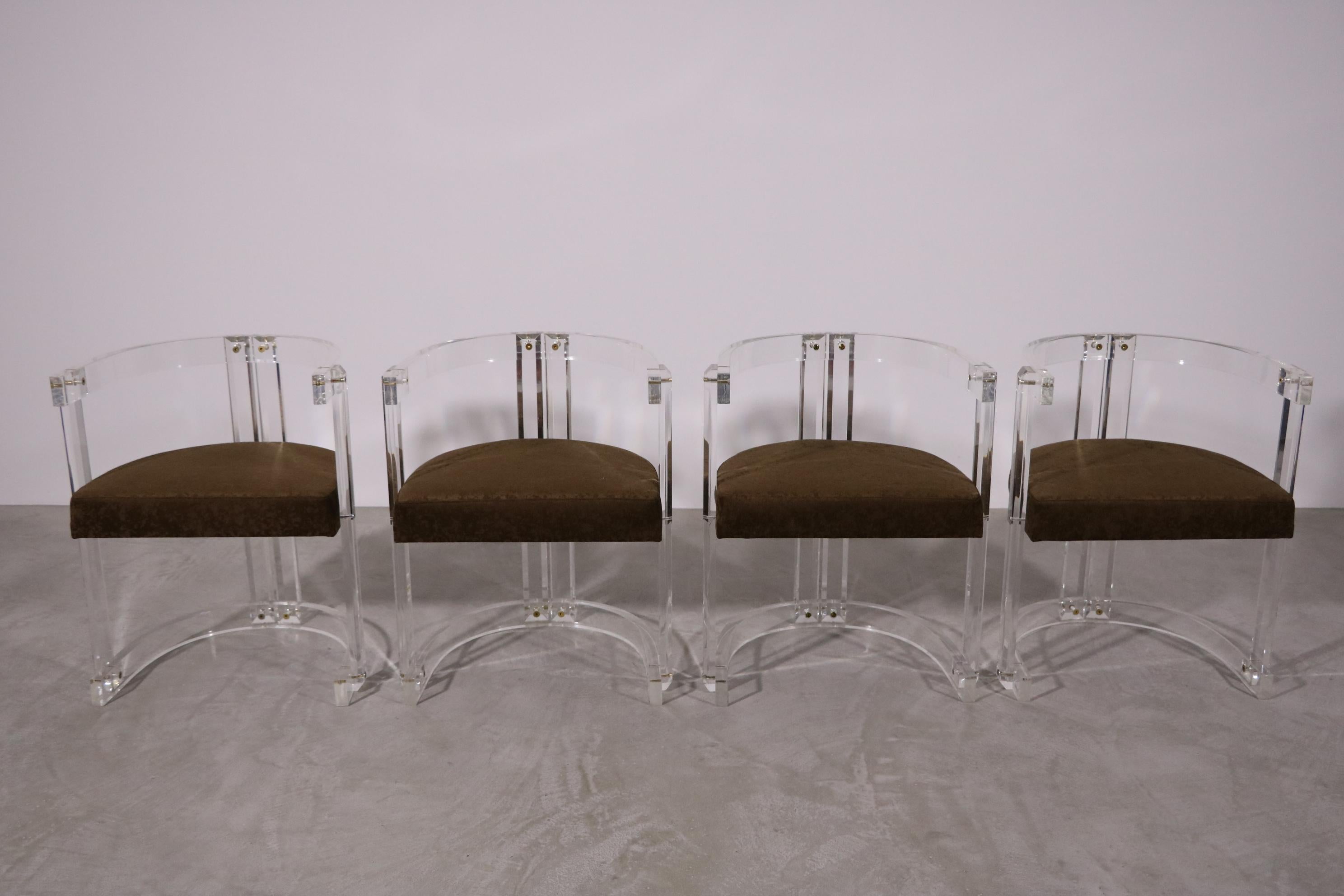 A beautiful set of 4 lucite dining chairs, exemplary and typical of the so-called Hollowood Regency style, created in the 1920-1950s, as a product of the Hollywood golden age, a period particularly known for its very own and special elegance and
