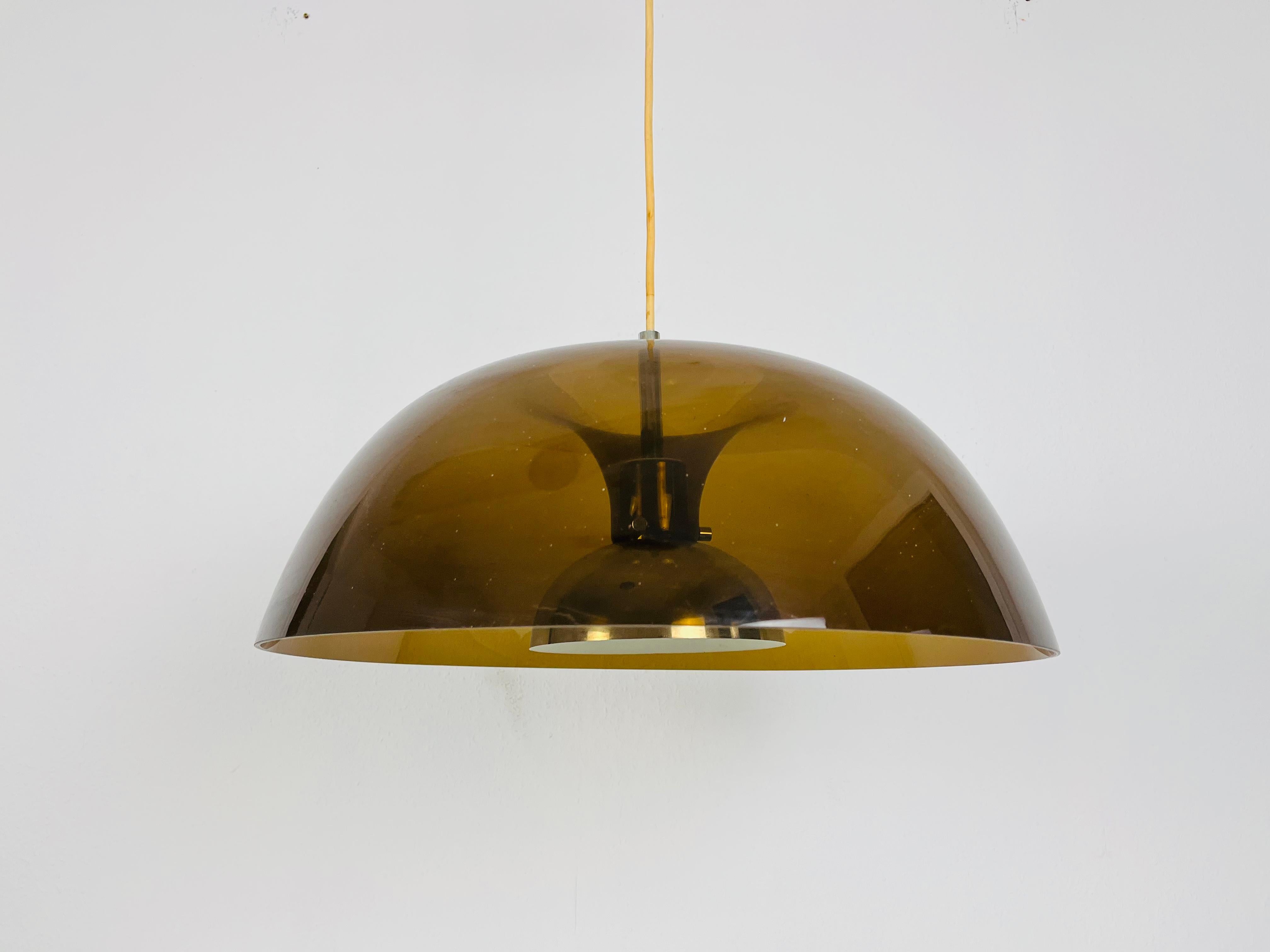 Vintage pendant lamp by Temde in the 1970s. It is made from acrylic glass and plastic.

Measurements:

Height: 20-80 cm
Diameter: 50 cm 

The light requires one E27 light bulb. Works with both 120/220V. Good vintage condition.

Free