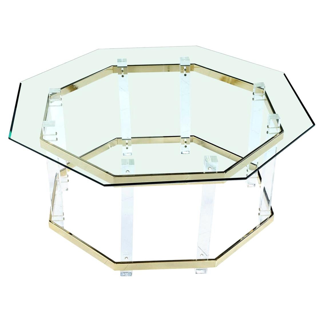 Vintage 1980s Charles Hollis Jones style Lucite and brass coffee table with beveled hexagon glass top. The geometric beveled glass top creates a silhouette mimicking the dynamic angles and form of the table base. Vertical acrylic architectural