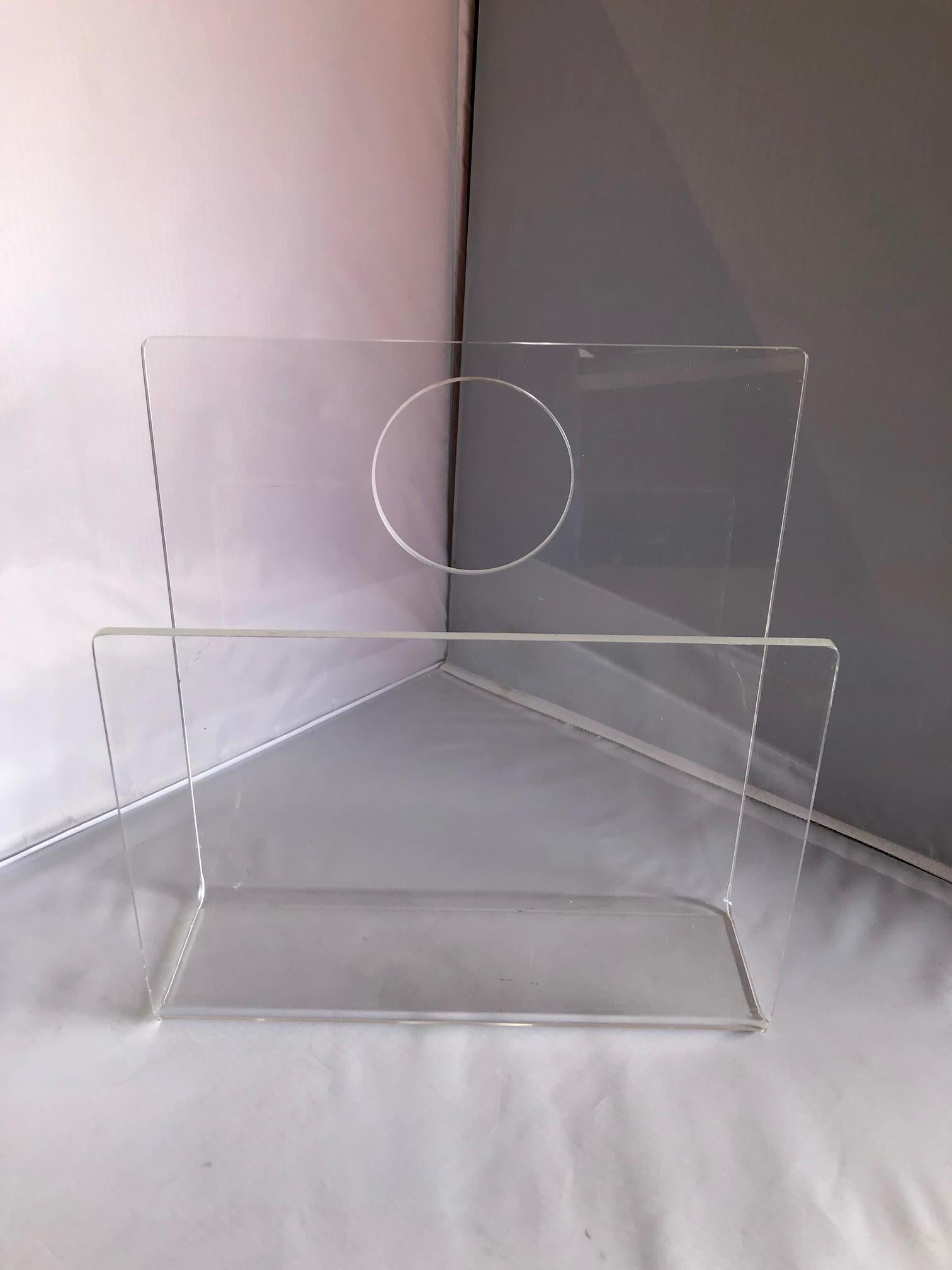 Mid-Century Modern acrylic magazine rack / holder by Ferguson of England, circa 1970s. The piece is in very good vintage condition with appropriate wear.