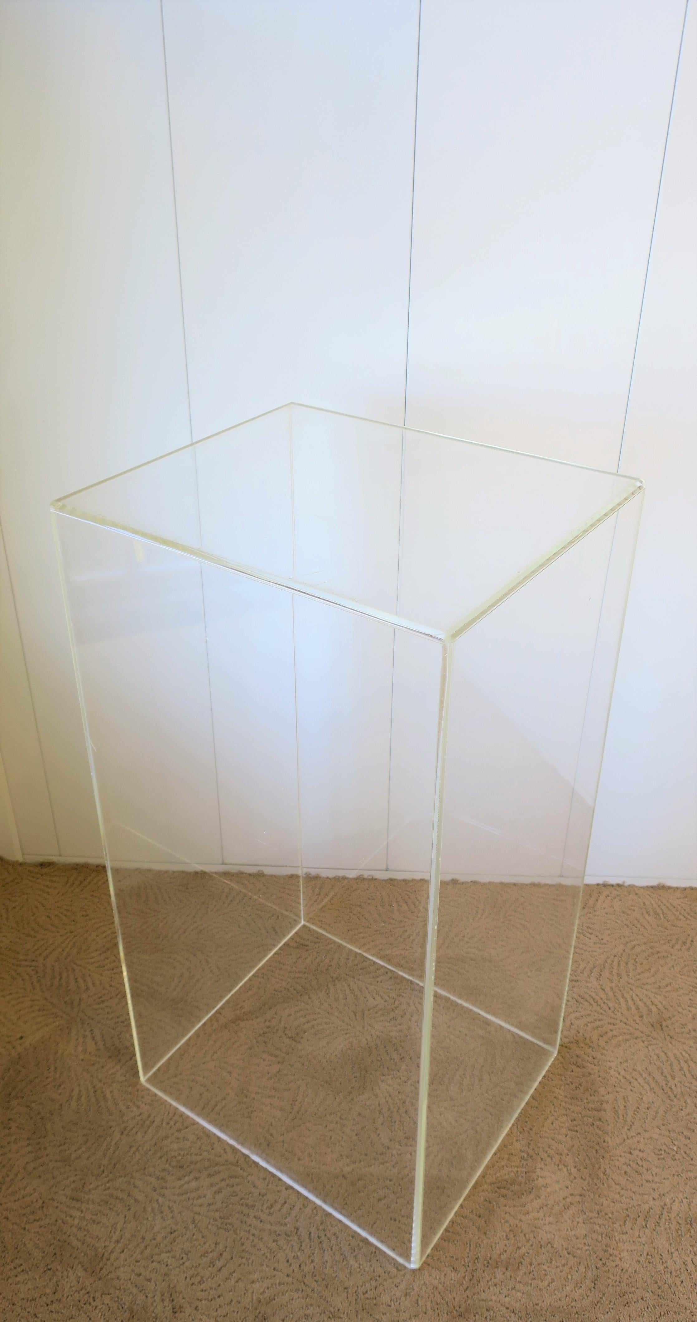 A substantial 36 inch tall rectangular Lucite/acrylic Modern style column pedestal stand display piece. Can be used to display items such as art, sculpture, jewelry, plant, etc.  

Measurements include: 9
