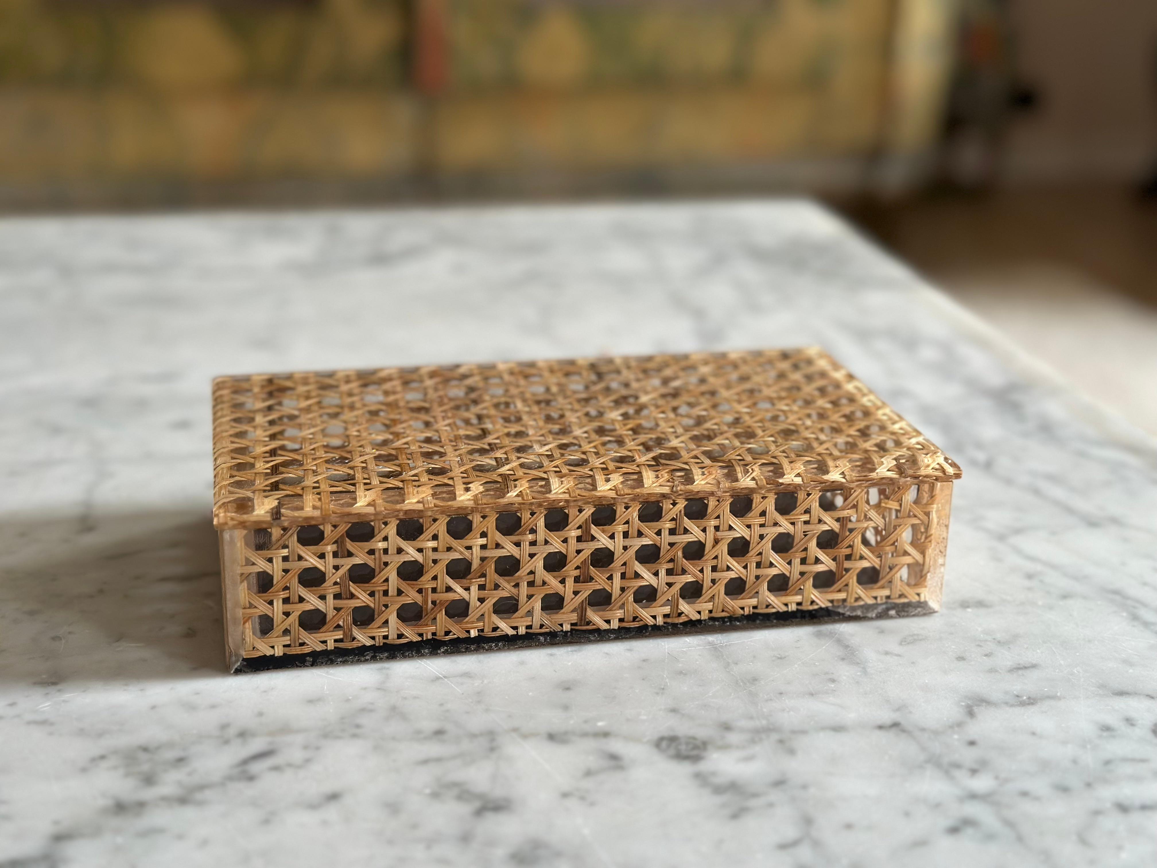 This striking rectangular box from the 1970s is crafted from acrylic with an unusual and eye-catching design. At first glance, it appears to be made of finely woven rattan, but in fact the rattan-style weave is cleverly embedded within the clear