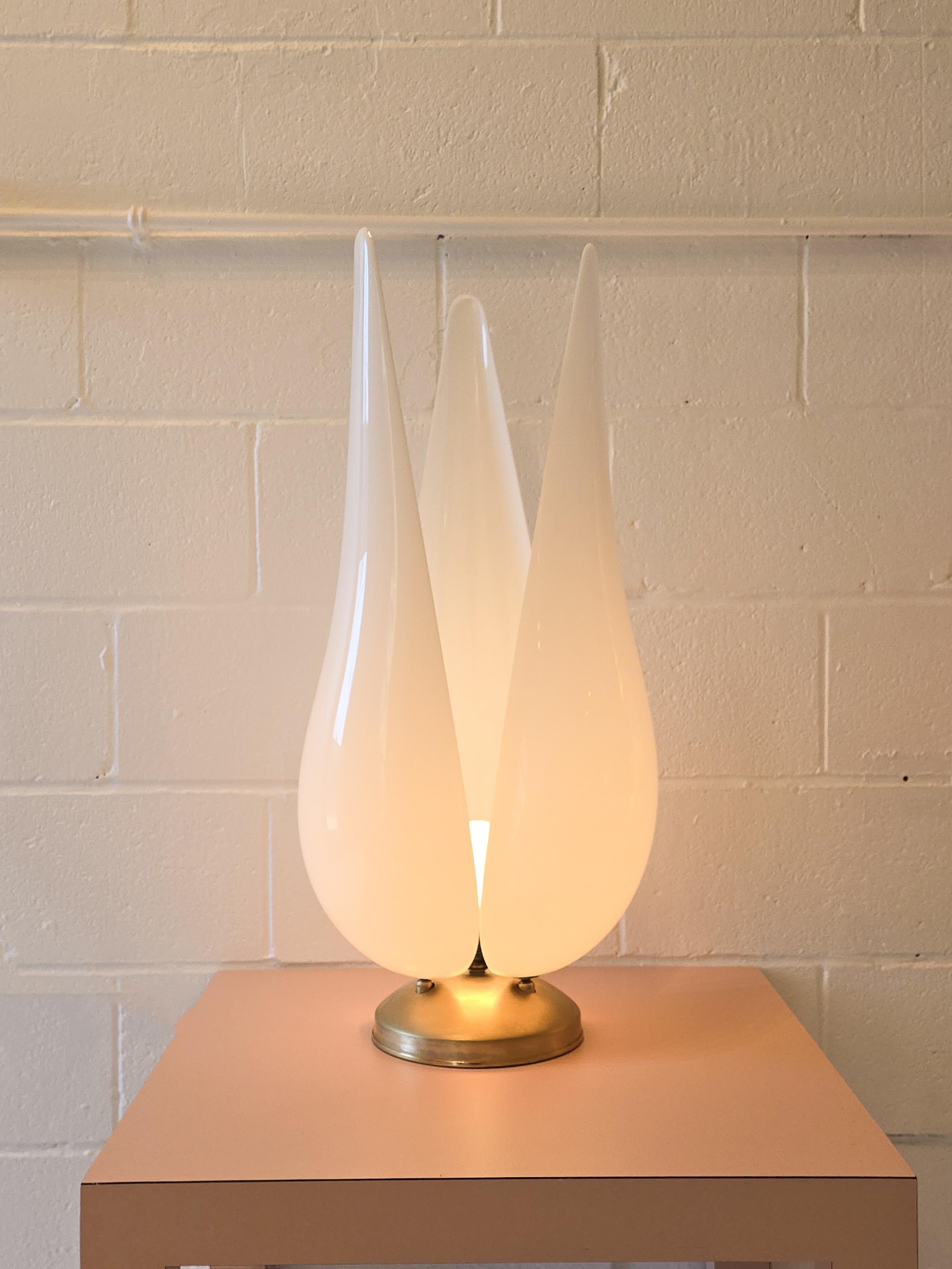 Gorgeous Acrylic tulip shaped tall lamp attributed to Rougier. It has three white acrylic shapes sitting on a metal base. The acrylic shades are each constructed in the shape of a petal, when combined to form the shape of a tulip. The metal base is