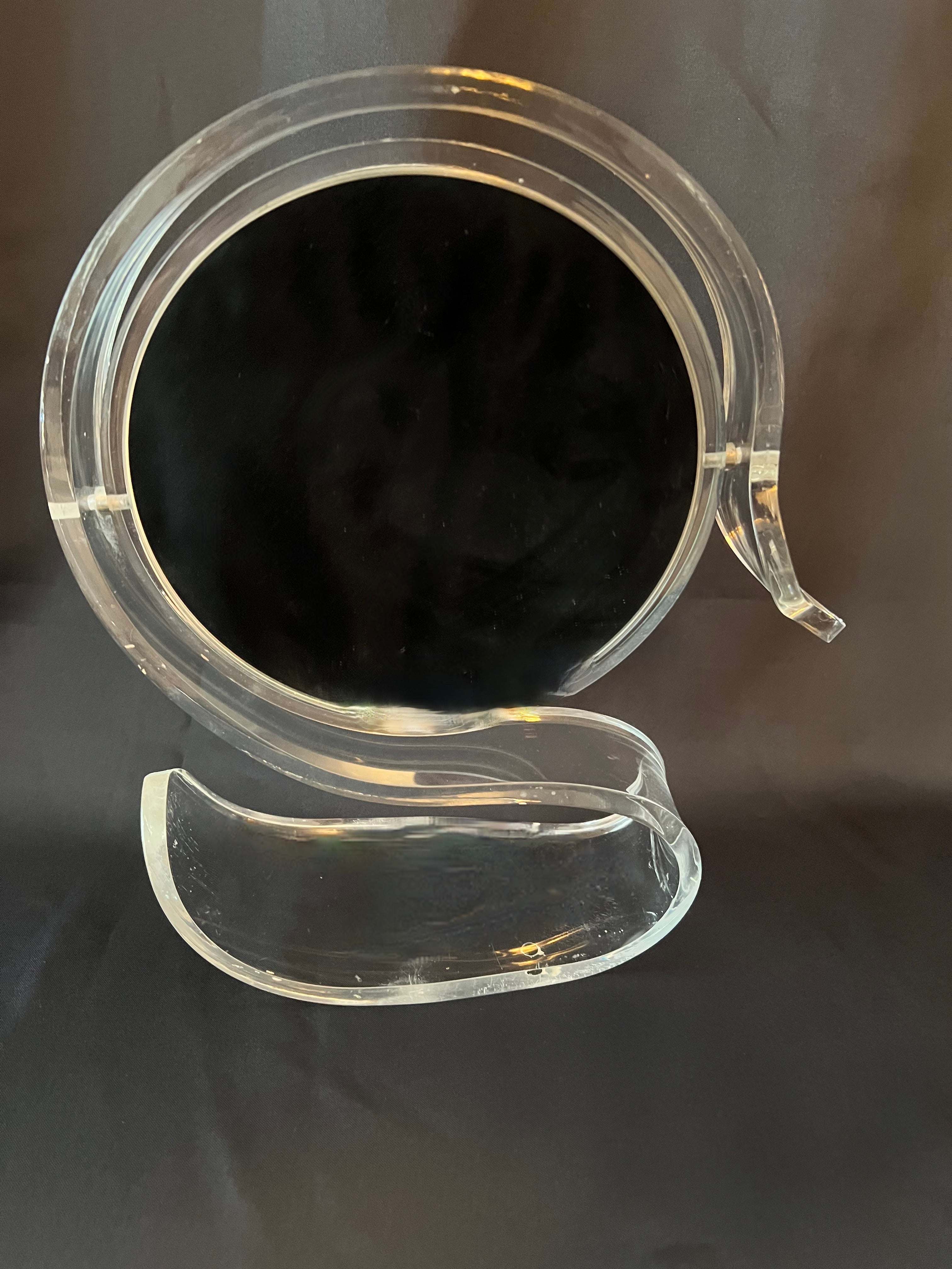 A lovely Acrylic or Plexiglass Mirror frame inspired by a swan... the frame is polished and the mirror is double sided and flips from regular to Magnification.  For those times when you need to see closer than normal for that perfect cat eyed lid -