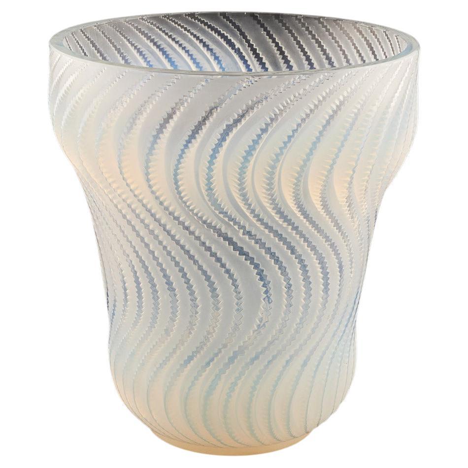 Actinia, an Art Deco opalescent glass vase by René Lalique (1860-1945). Raised, swirling pattern in graduated blue green opalescence with a peach coloured tint. Etched 'R Lalique France' to underneath. Photographed with different light exposure to