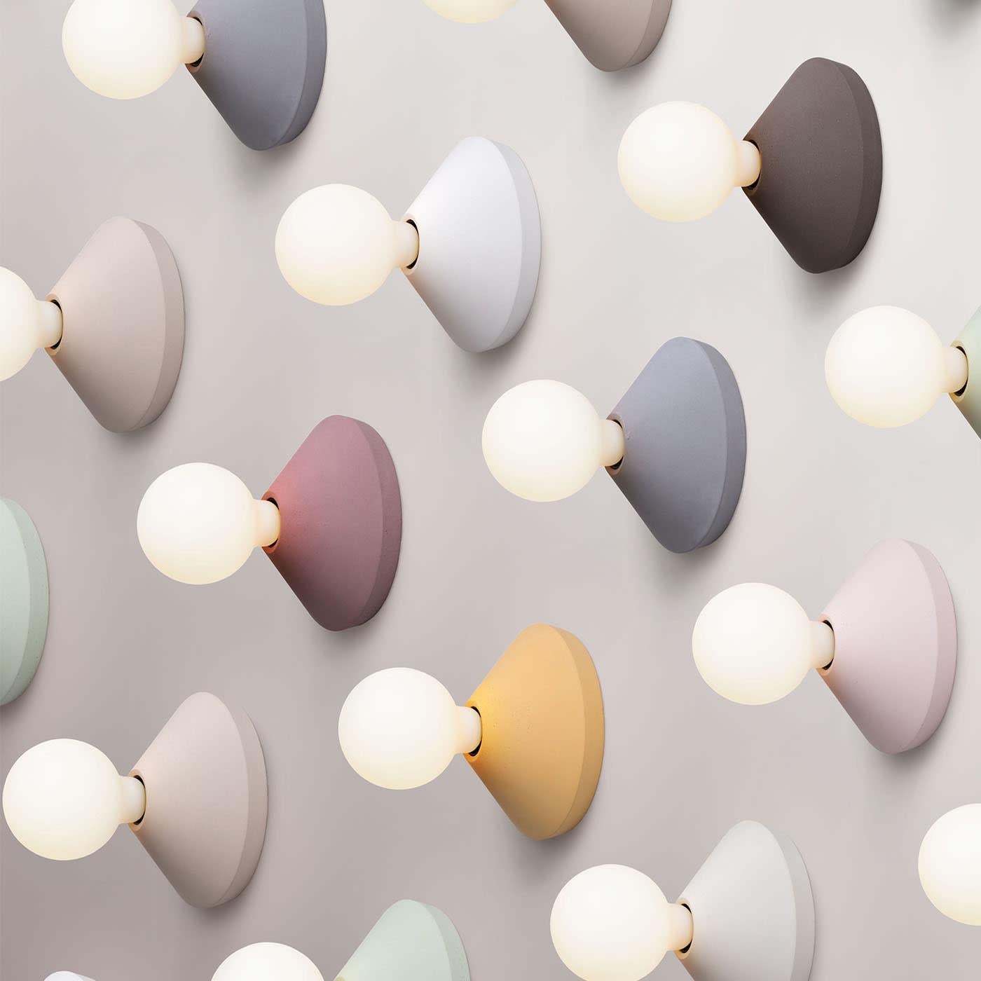With its circular timeless shape, Ada is a decorative lamp that lights up both the surrounding environment and the concrete disc, highlighting its handcrafted surface, its contemporary design, and its color. Ada is a versatile lamp that can be used