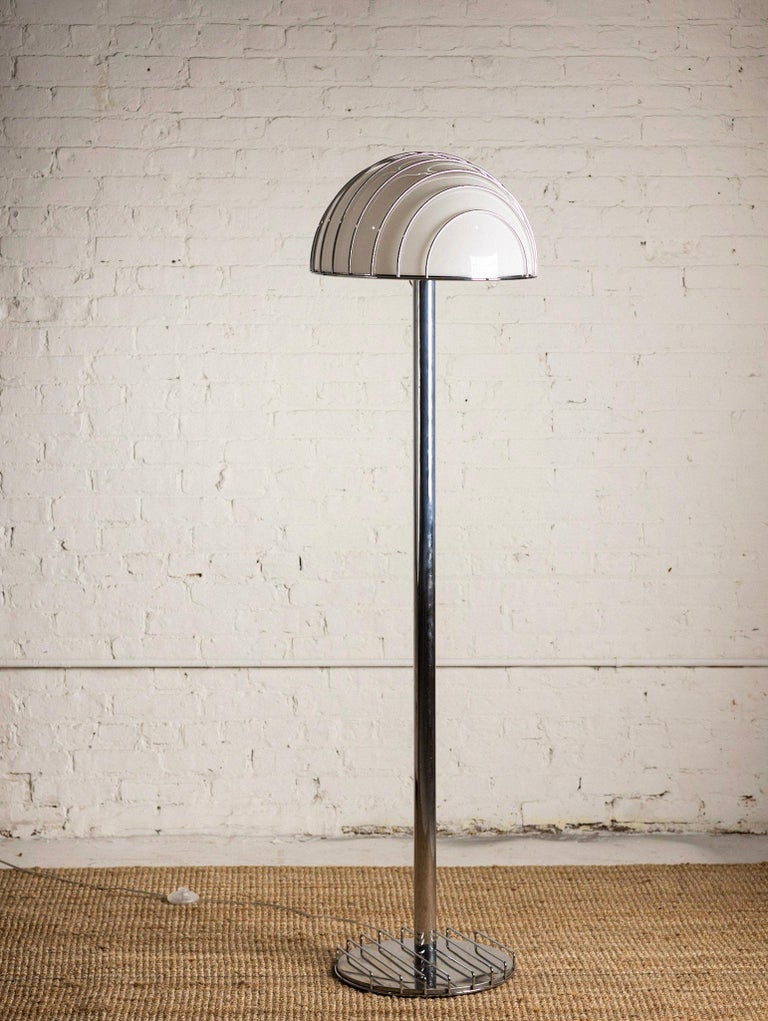 A space age floor lamp designed by Milanese architect and industrial designer Adalberto Dal Lago for Esperia. The “Griglia” or Grid floor lamp consists of an acrylic dome within a chrome cage. Heavy chrome stand and caged chrome base.