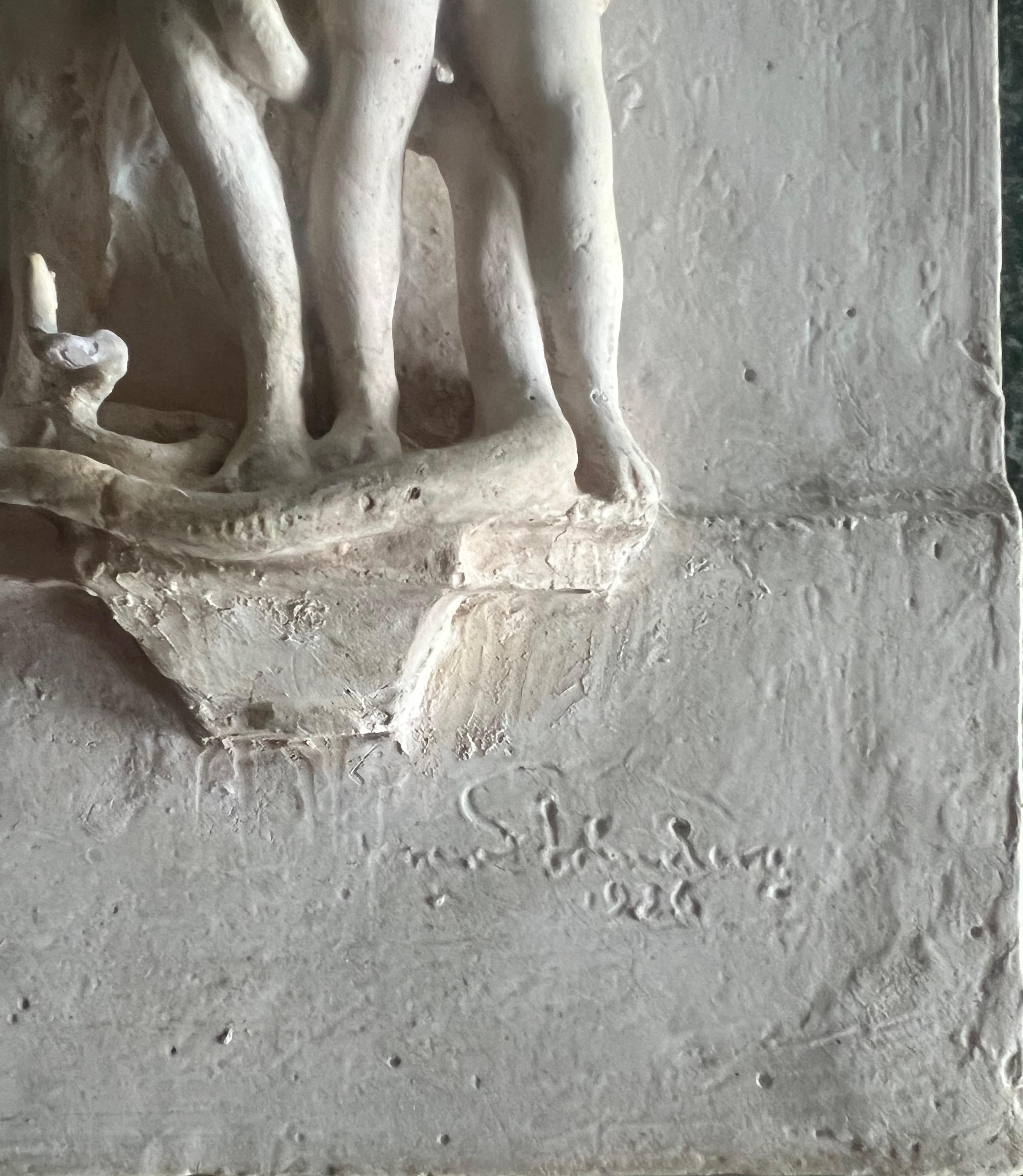 A fine small amusing plaster wall sculpture by Tore Strindberg (1882-1968). The subject is Adam and Eve in the garden of Eden with Eve offering Adam an apple from the tree of knowledge of good and evil and he is just about to take a bite. A serpent