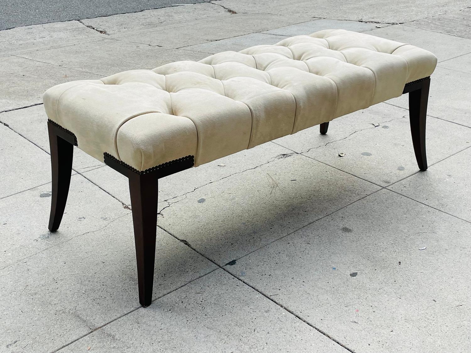Beautiful bench designed by Thomas Pheasant and manufactured by Baker furniture, made in the USA.
The piece has beautiful lines, upholstered in an ivory color suede with nail head on the corners.
The legs are stain in a mahogany finish.

The