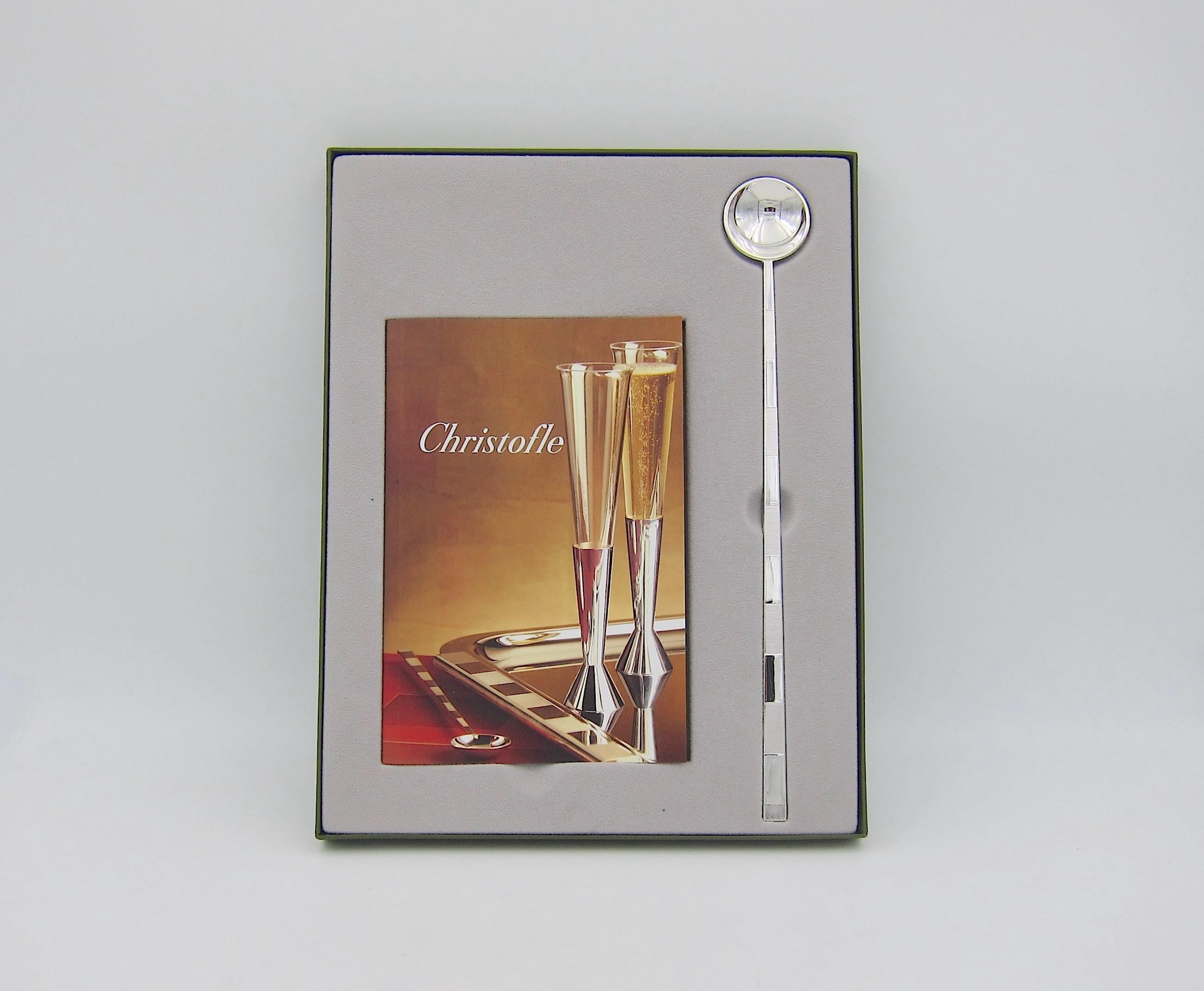 A boxed Christofle of Paris Collection 3000 pattern cocktail spoon designed by American architect and hospitality designer, Adam D. Tihany (b. 1948). The elegant and substantial silver plated spoon is pictured on the cover and on pages 13 and 34 of