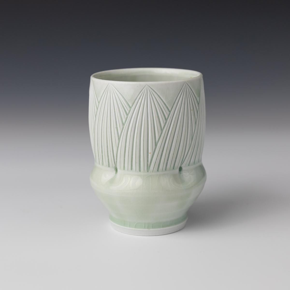 This elegant cup was created by Montana based ceramicist, Adam Field. The cup incorporates Field's love of ancient pottery entwined with the functionality of Colonial American Ware. Inspired by nature, many of Field's forms contain a variety of