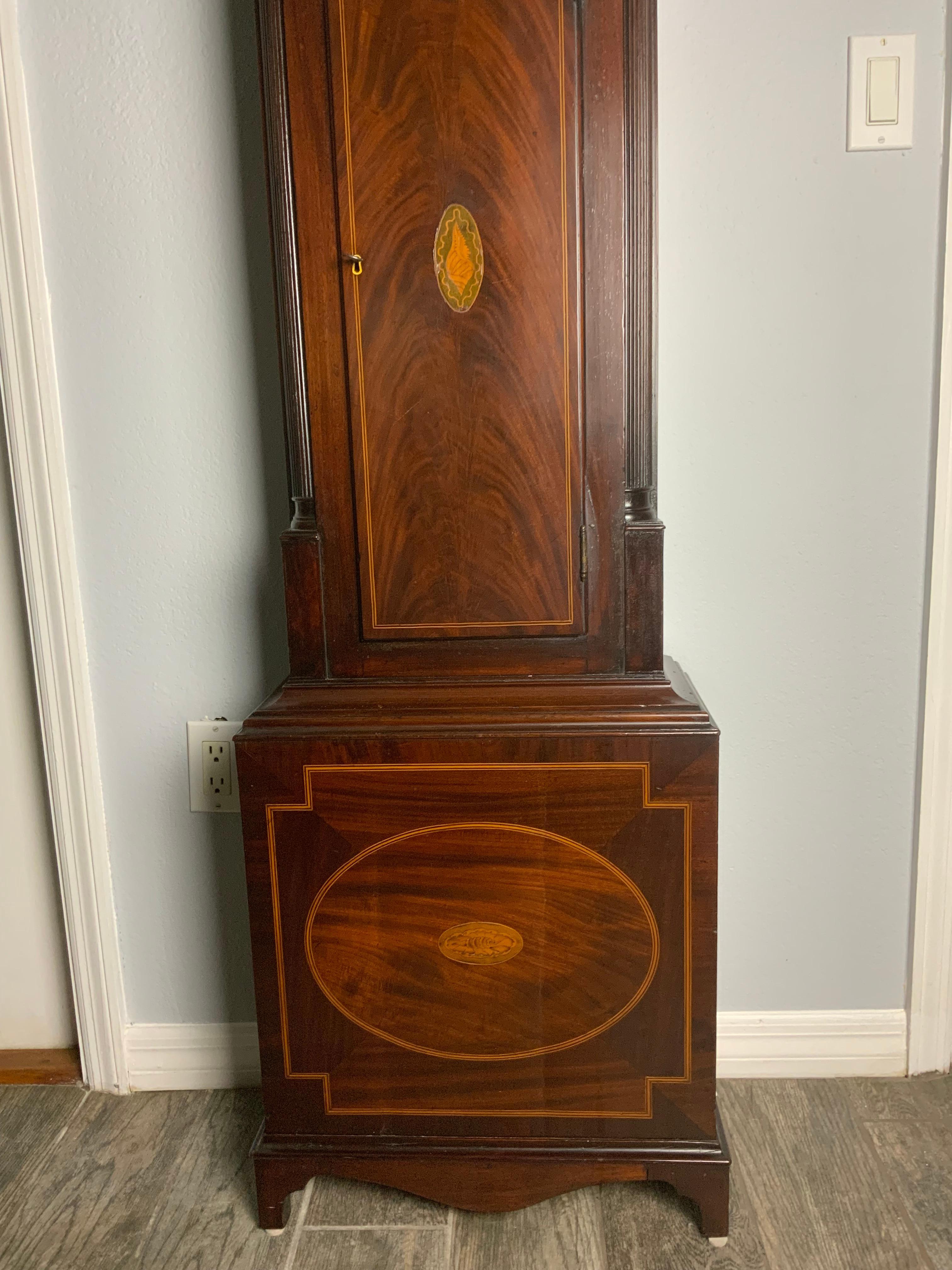 A very attractive 18th century Tall Case Clock by Adam Gordon Dunkeld of Scotland. Beautifully proportioned Inlay Mahogany case with a Broken arch pediment bonnet with side windows and reeded quarter columns. Delicately hand engraved silvered dial