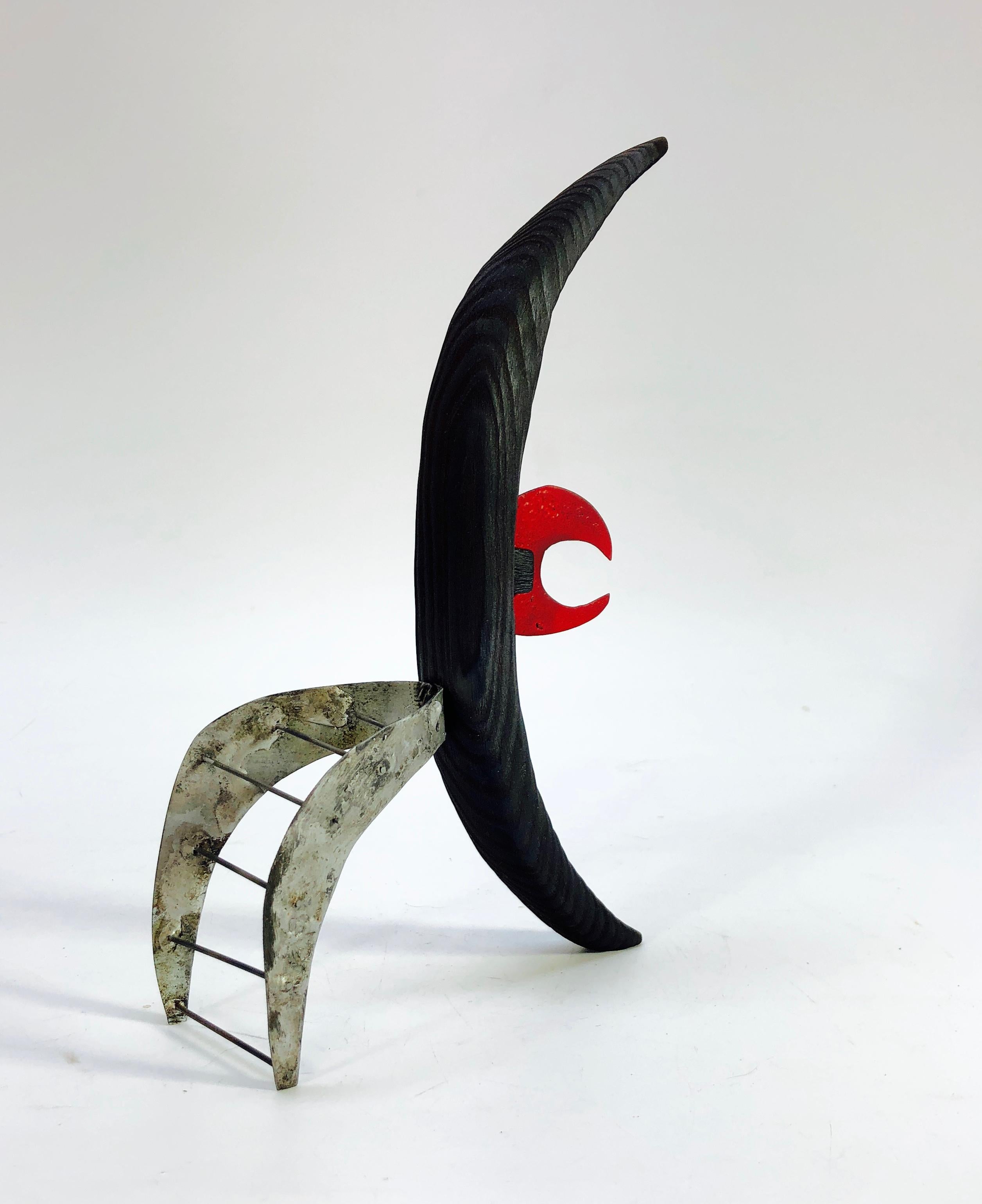 Adam Henderson's open window abstract sculpture comprised of 4 crescent shaped pieces in wood and sheet metal.