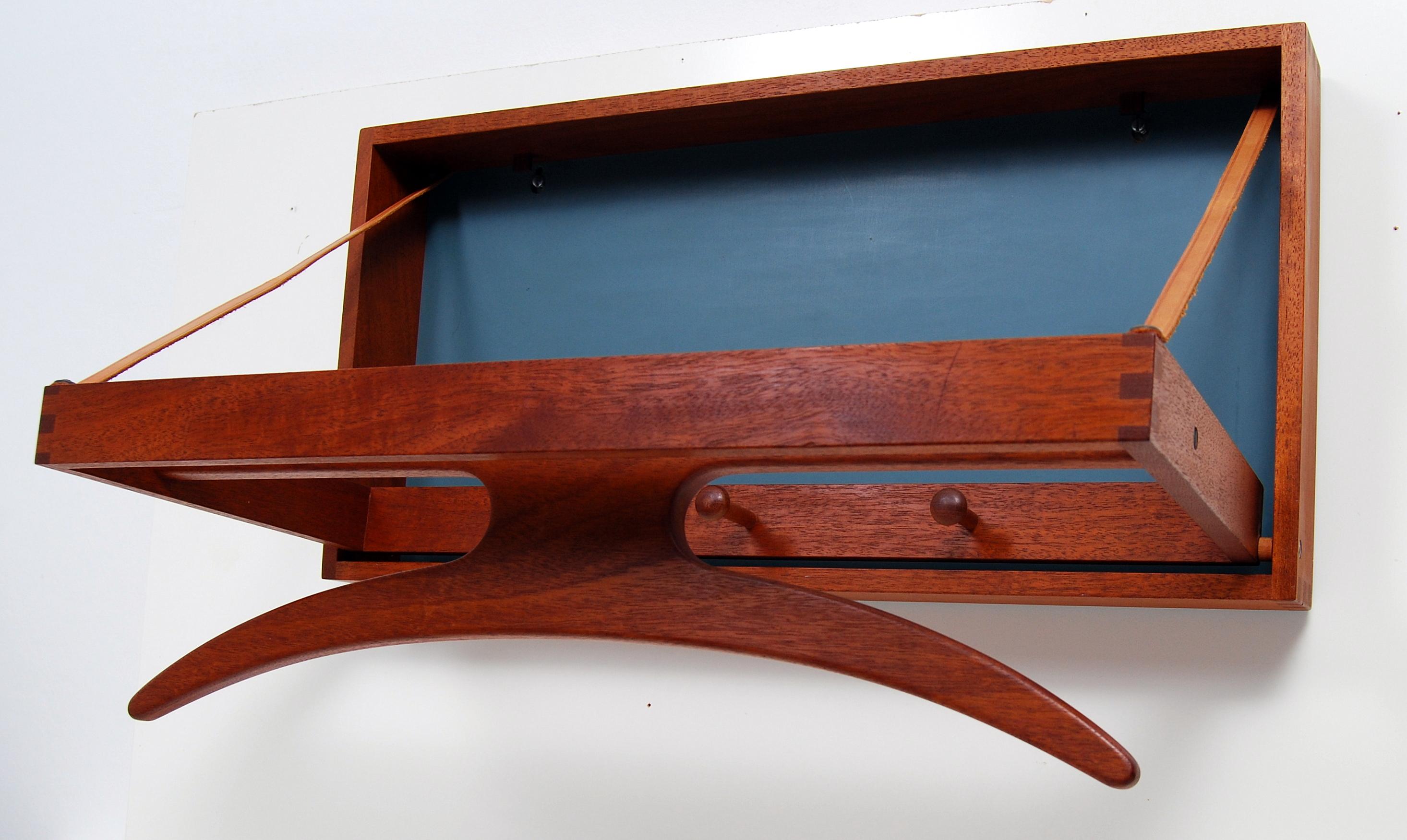 Danish wall valet Trip-Trap designed by Adam Hoff & Poul Østergaard for Virum Møbelsnedkeri in 1964. Made of solid teak and with a formica back. Very good condition.
 