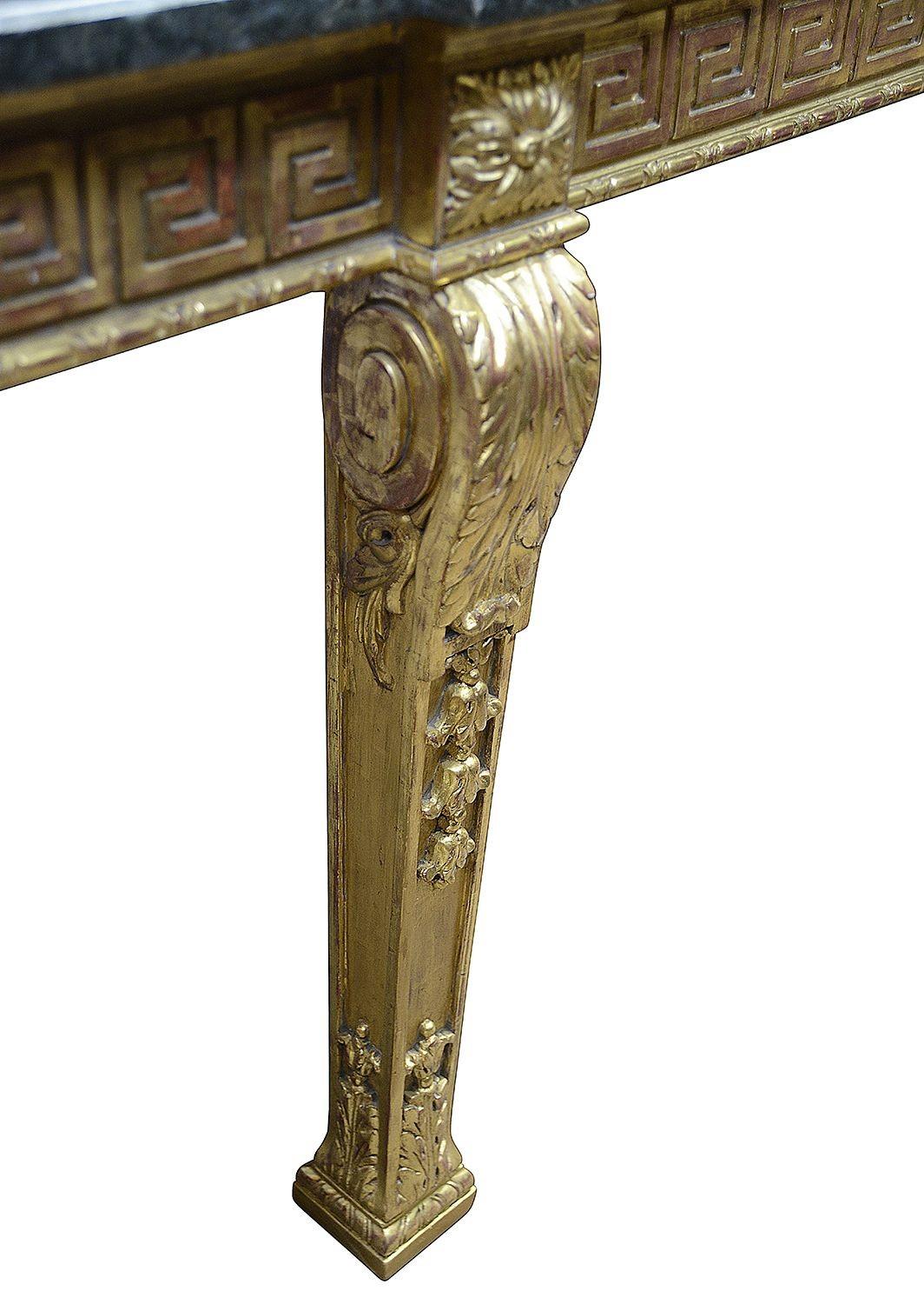 A very good quality late 19th Century classical Adam influenced carved giltwood, marble topped table, having Greek key pattern to the frieze which has a central drawer, scrolling acanthus leaf decoration to the top of the four square section
