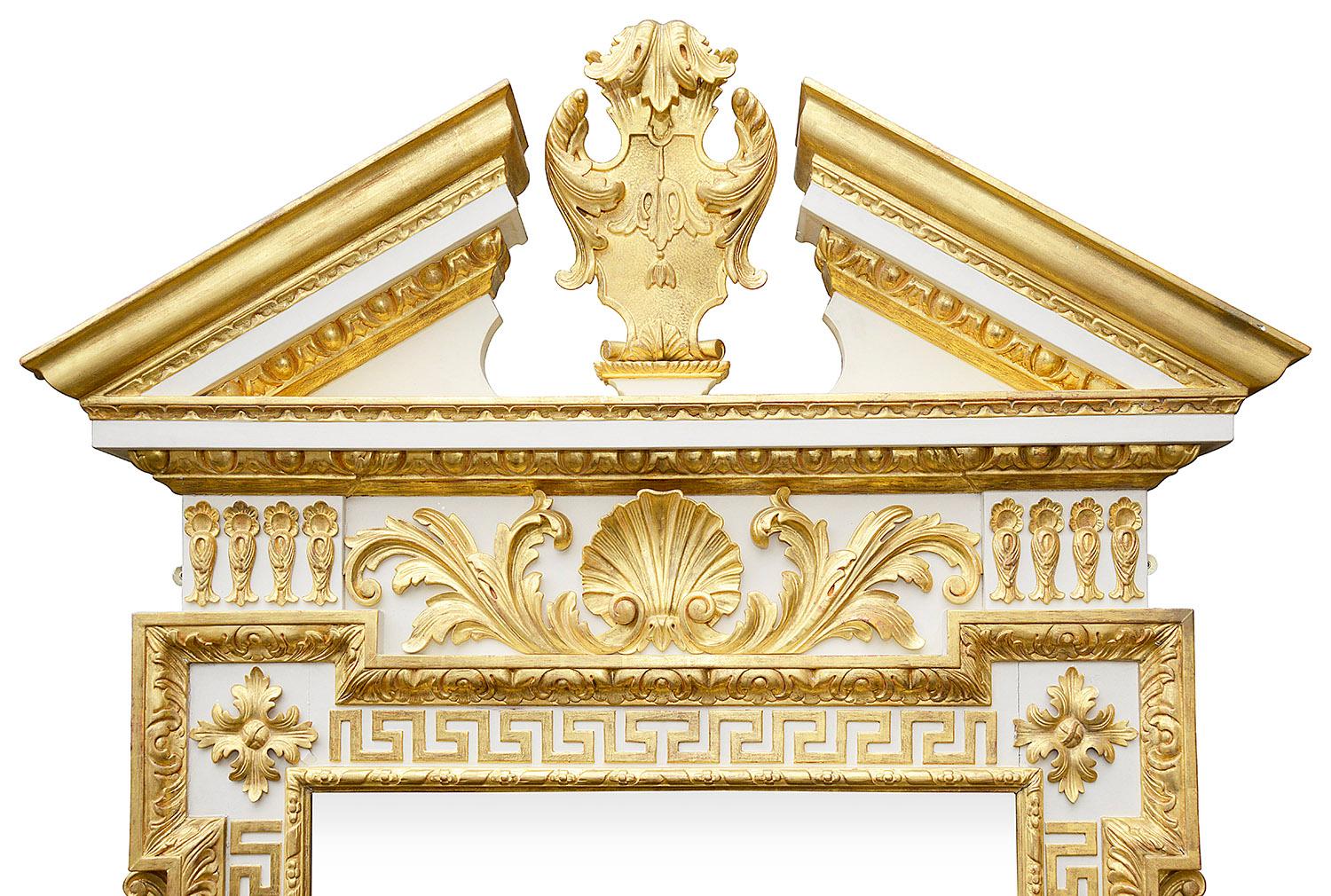 A very good quality 18th Century Style carved gilt wood and ivory coloured decoration.

Having an architectural pediment with a carved cartouche to the centre, egg and dart carved mouldings, shell, motif and greek key pattern decoration.
 