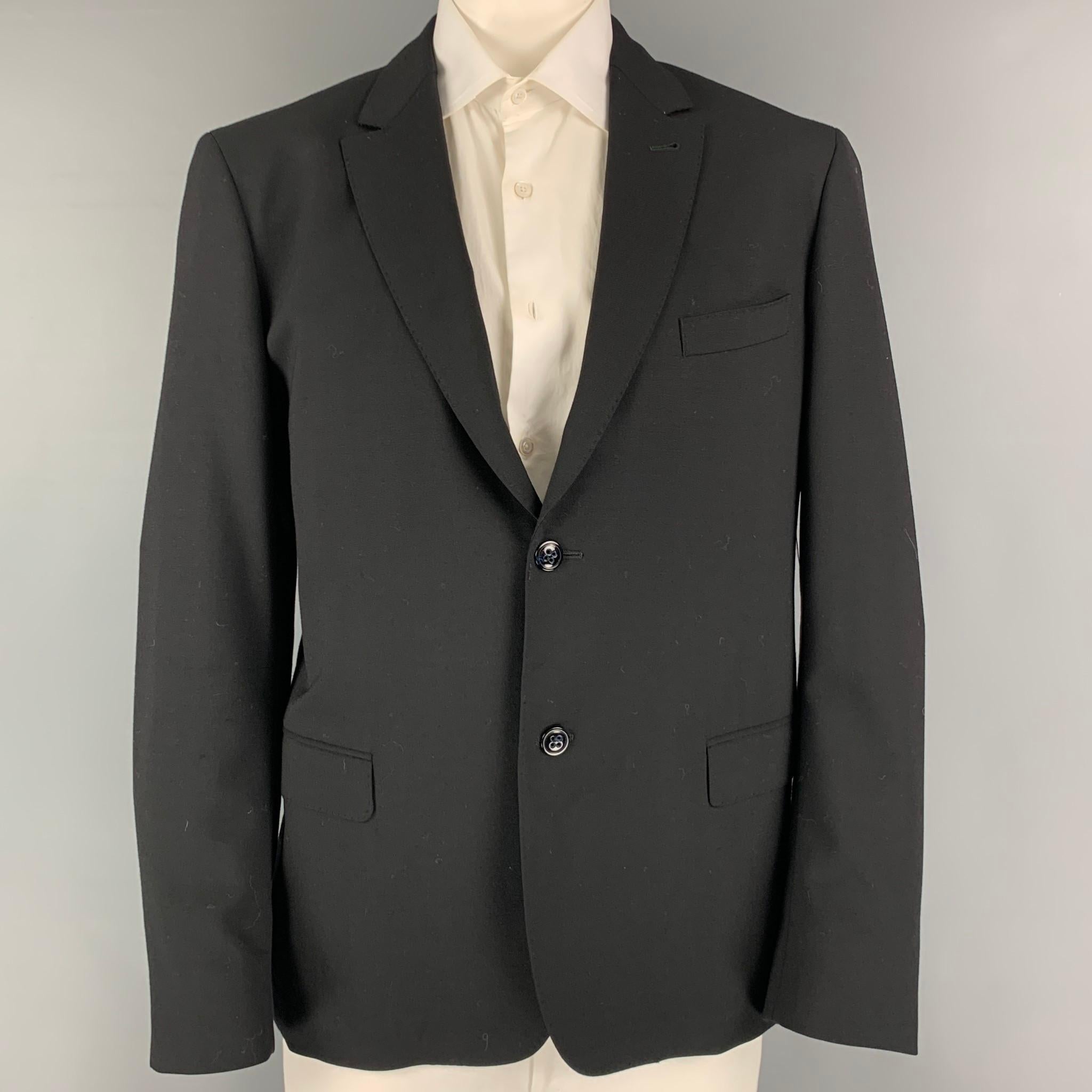 ADAM KIMMEL sport coat comes in a black wool with a full liner featuring a notch lapel, flap pockets, double back vent,and a double button closure. Made in Italy.

Excellent Pre-Owned Condition.
Marked: XL

Measurements:

Shoulder: 20 in.
Chest: 42