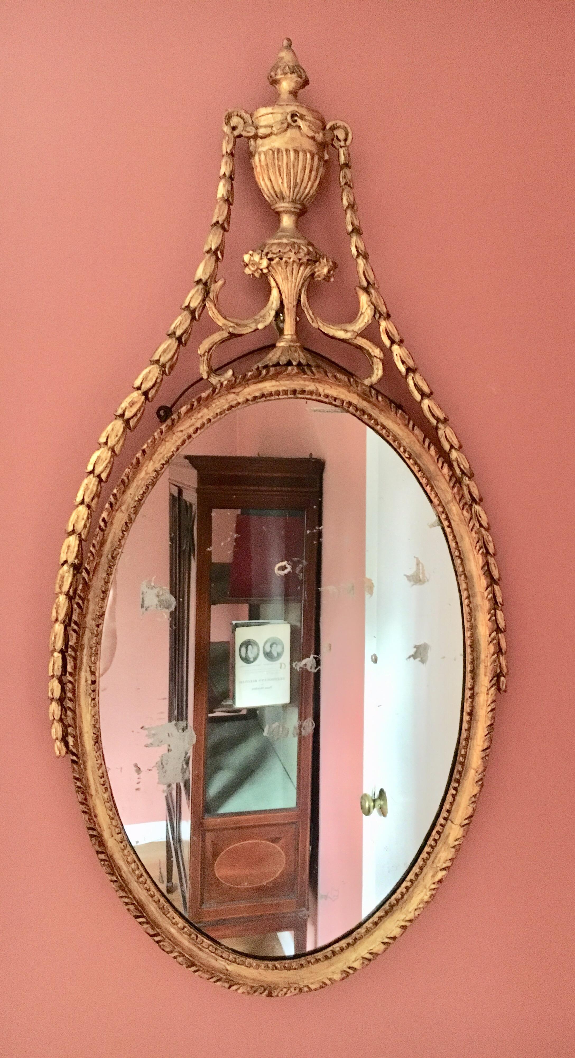 Beautiful antique late 18th century neoclassic oval gilt wall mirror in the manner of Robert Adam. Stunning and elegant, this 'Etruscan' style was not only popular in England in the late 18th century, but also made its way to the nobility in Denmark