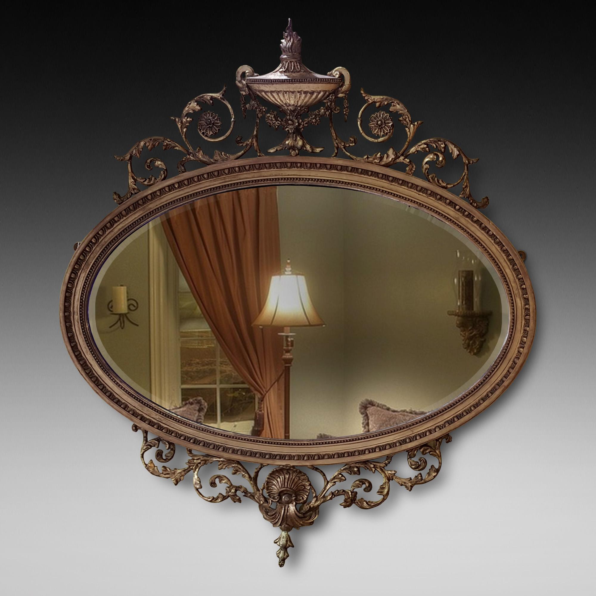 Late 19th century Adam Revival giltwood and gesso mirror decorated with urn capital, foliage, rosettes and shell.
Measures: 36