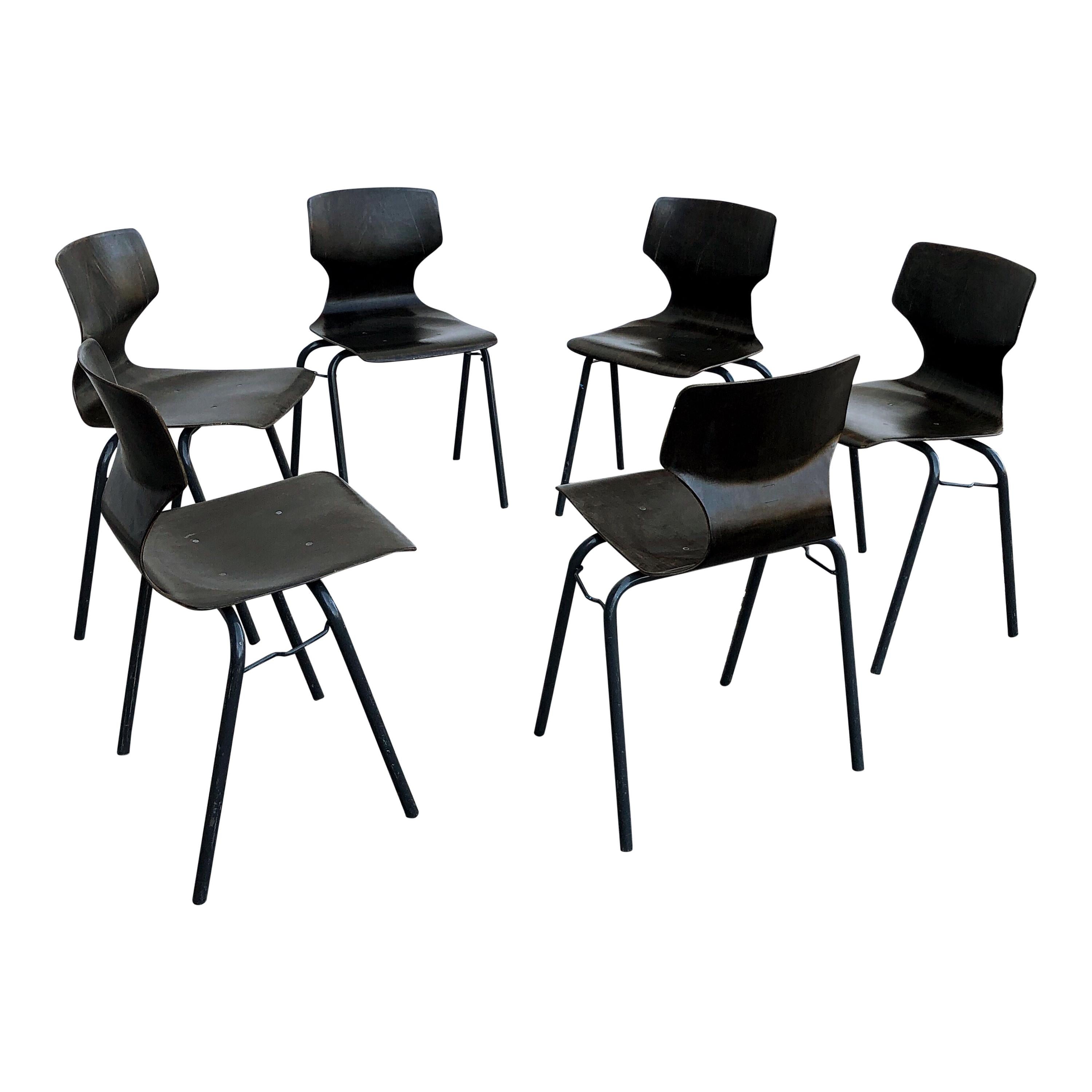 Beautiful Industrial stackable strength molded chairs designed by Adam Stegner. 
Made from strong Pagwood shaped seats (Pagwood is high density laminated compressed wood, with orthopedic pelvic and back support without adjustment), set on strong