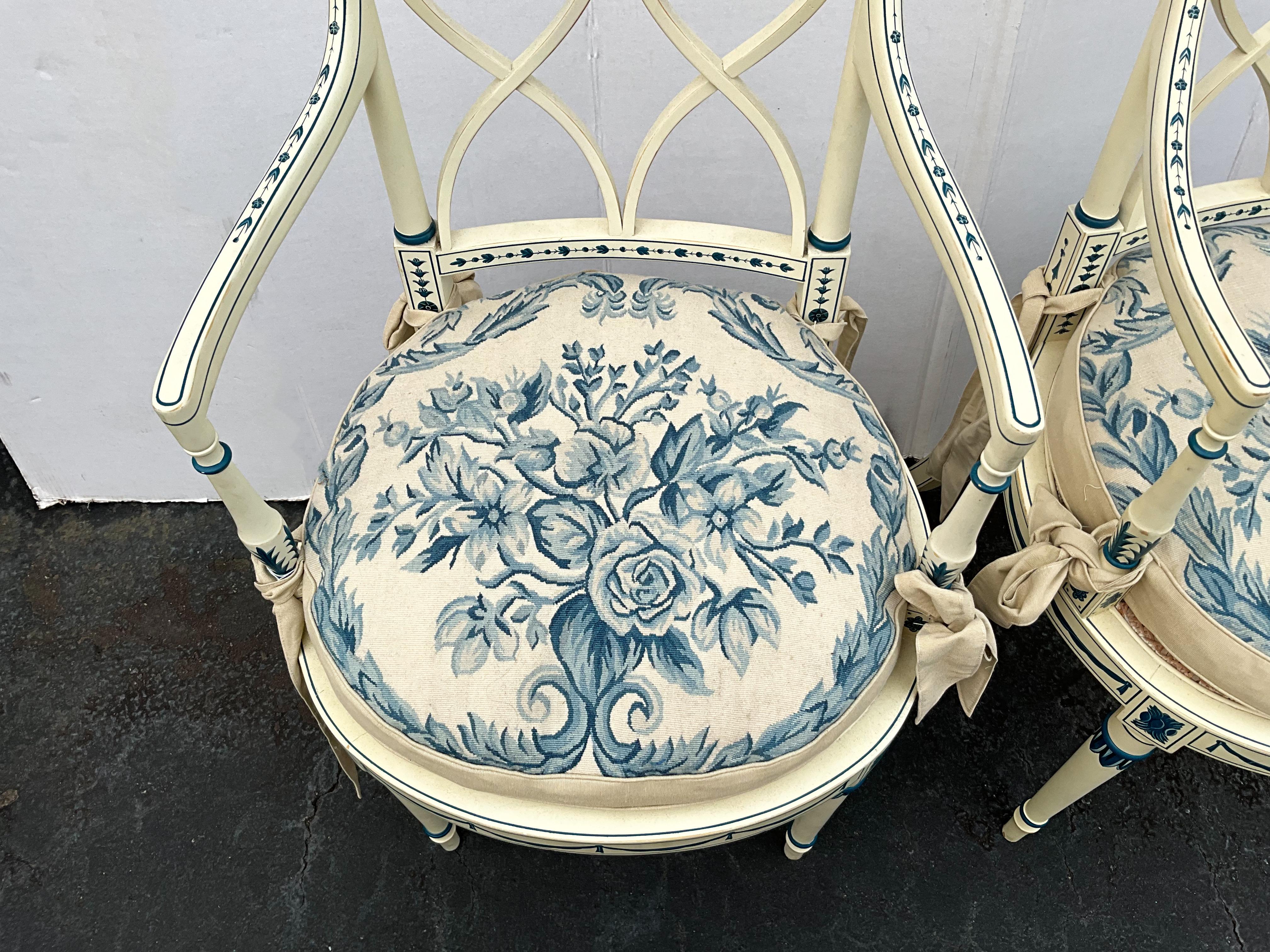 These are my new favorite chairs…until the next favorite. Smiles. This is a pair of Adam style hand painted Bergere chairs with beautiful needlepoint cushions. The interior is down. The caning is in very good condition. They are ivory with blue