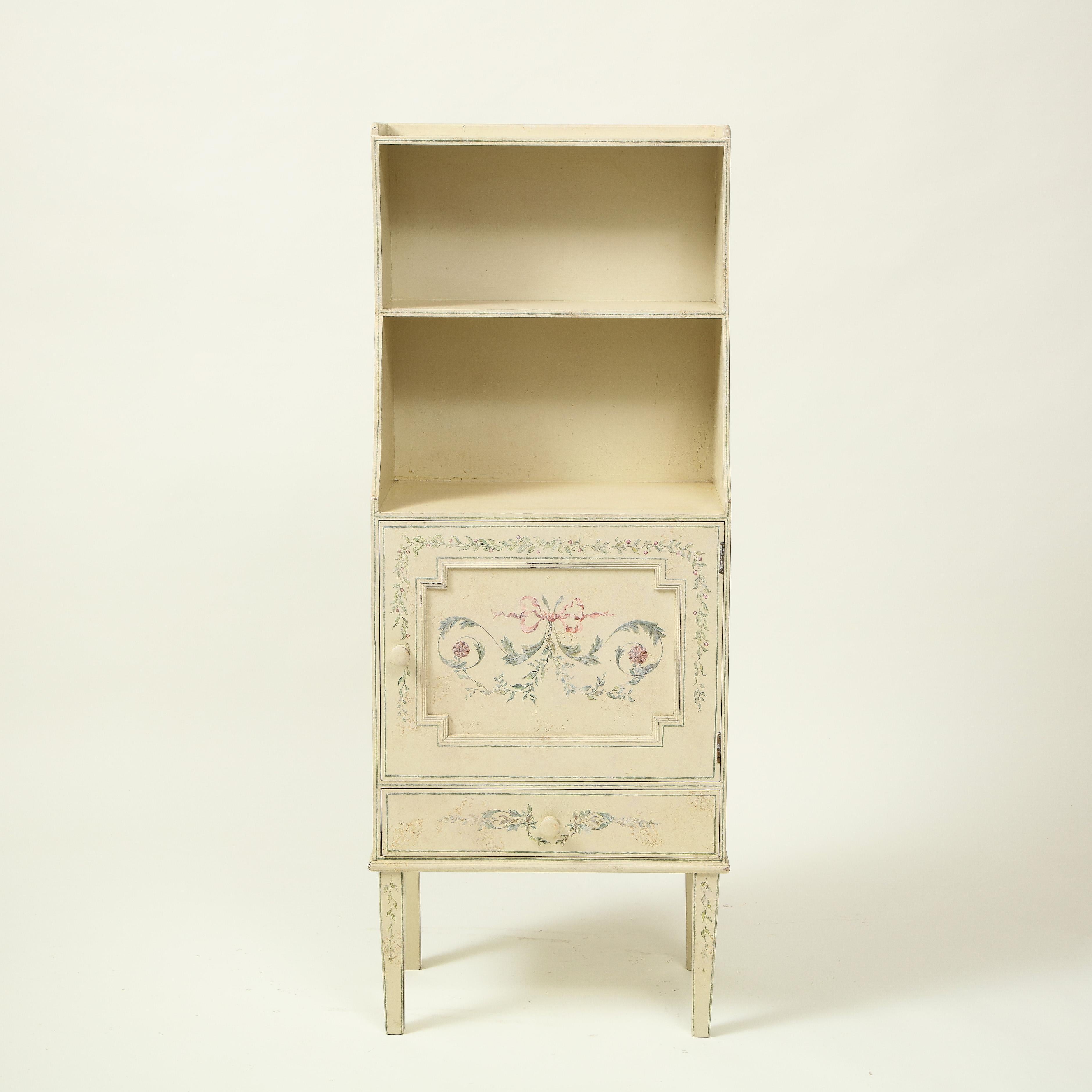 Fitted with two shelves over a paneled cupboard door and single drawer; raised on square tapering legs; decorated overall with polychrome arabesque decoration.

Provenance: From the Collection of Mario Buatta, New York, NY

Note: Sister Parish