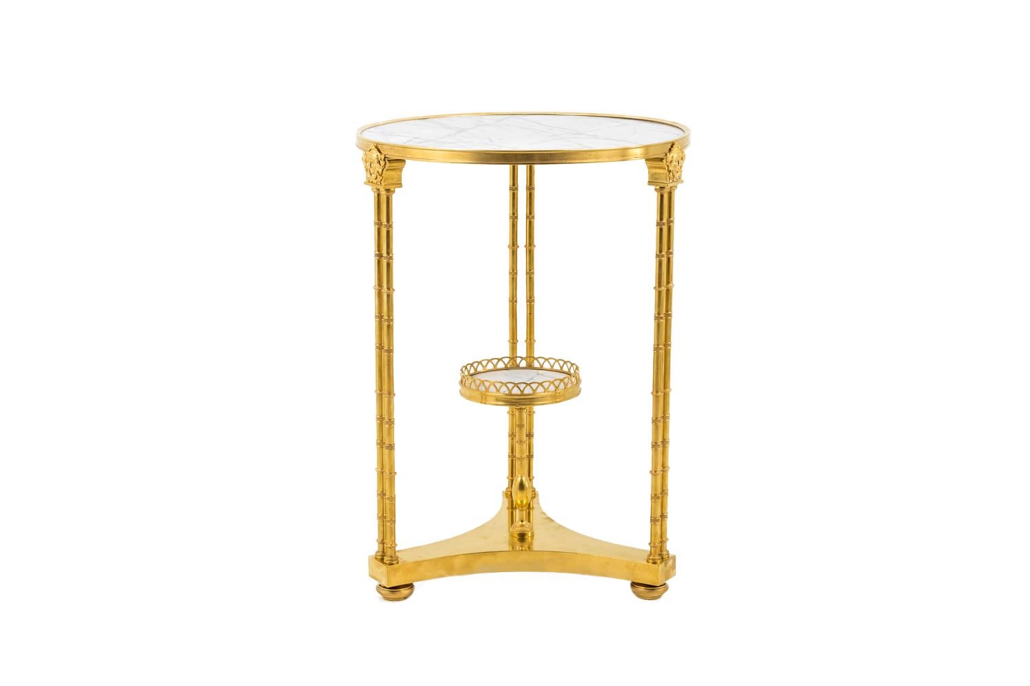 Adam Weisweiler, in the style of. 

Neoclassical style circular Stand in chiselled and gilt bronze standing on three legs in flattened ball shape. They are linked each other by a triangular lower shelf with curved sides supporting a small white