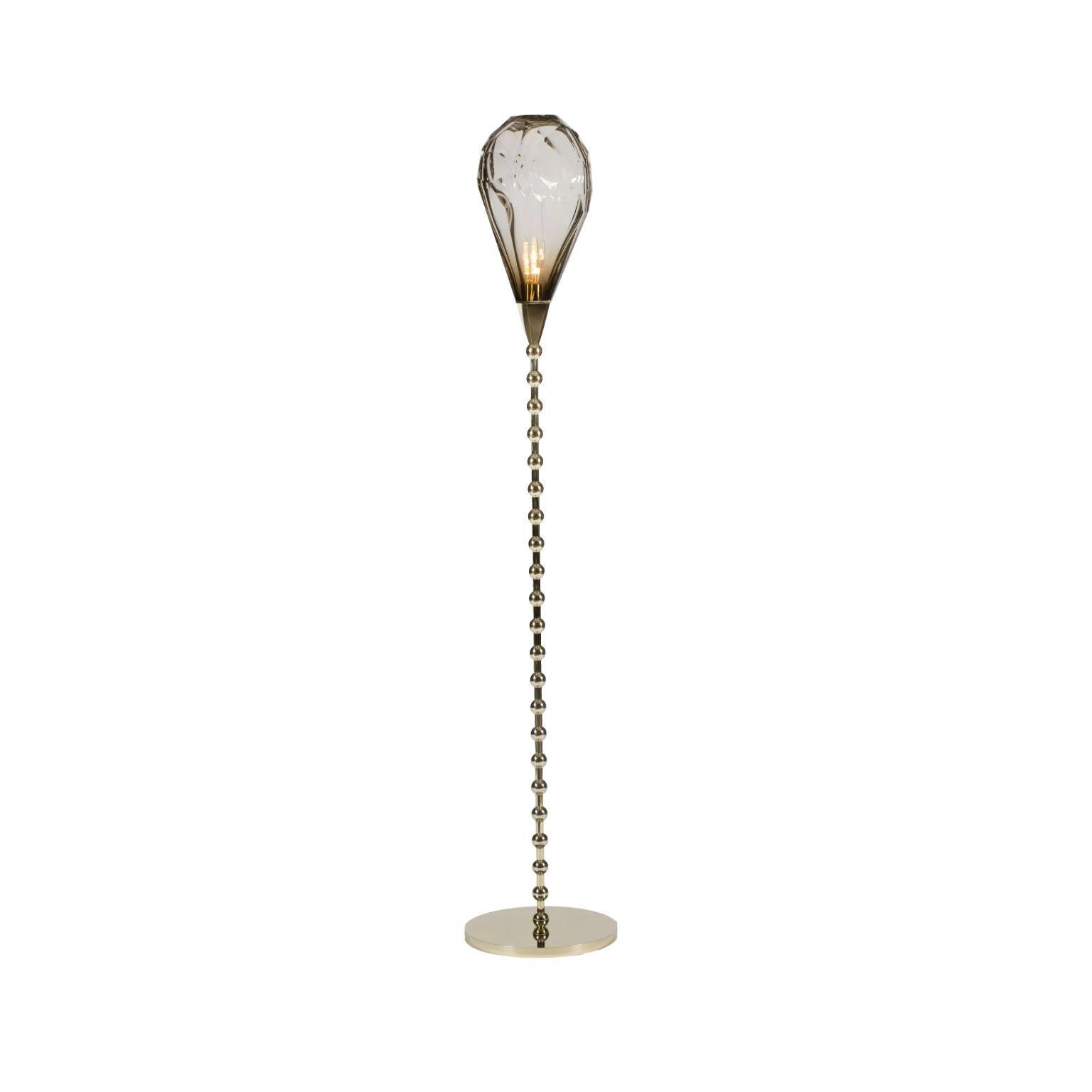 Adamas floor lamp by Emilie Lemardeley
Dimensions: D30 x H160 cm
Materials: Brass, Glass
Weight: 35 kg

The ADAMAS lightings take their inspiration from Greek myth; the story of a young man transformed into a precious stone, a diamond, by the