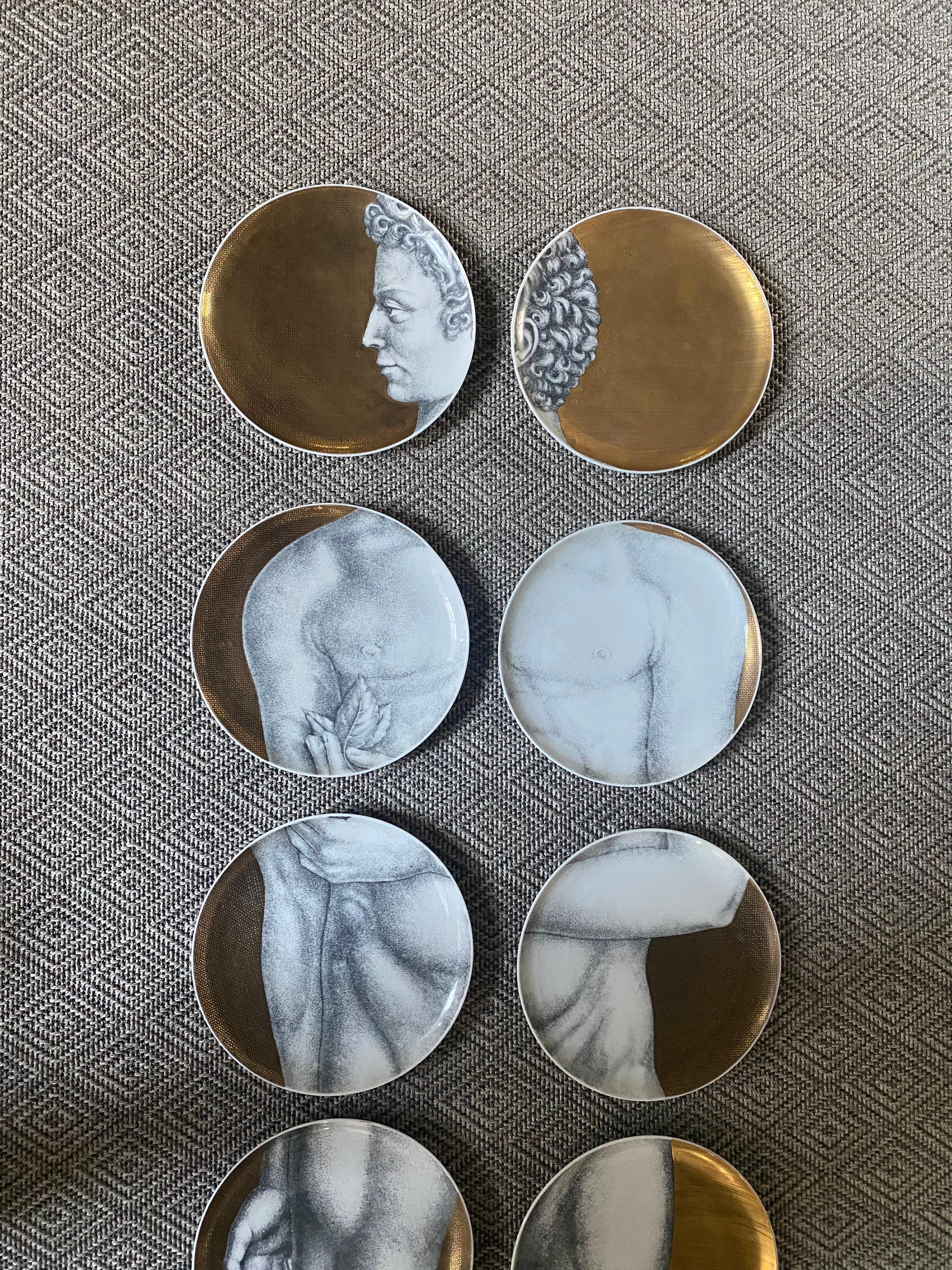 Spectacular set of 12 Fornasetti ADAMO plates with detailed gold background - not the newer flatter plain gold.

