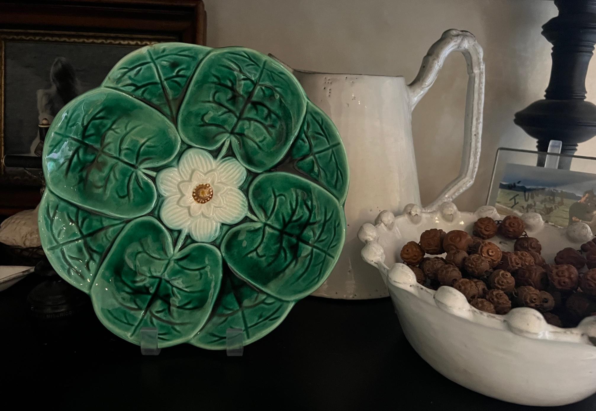 Antique majolica made by Adams and Bromley in the late 19th century. The plate has vibrant green leaves surrounding a central white flower with hints of blue.

This is the larger of the two Adams & Bromley plates in the same pattern, one is 8 inches