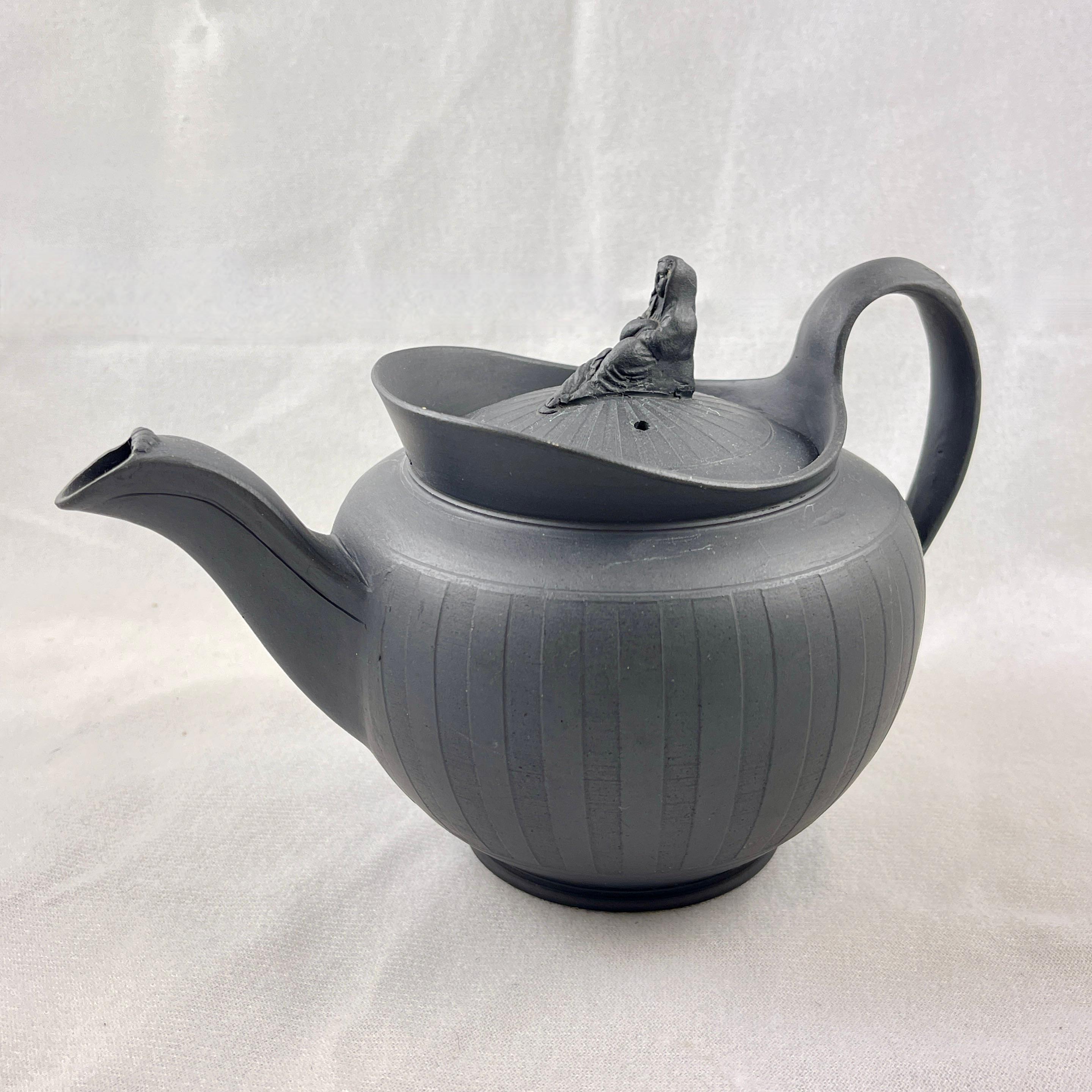 A scarce black Basalt engine-turned teapot, attributed to William Adams I (1746-1805) Burslem, Stoke-on-Trent, England, circa 1790.

William Adams I was an accomplished potter whose best known products included stonewares, jasper and basalt of the