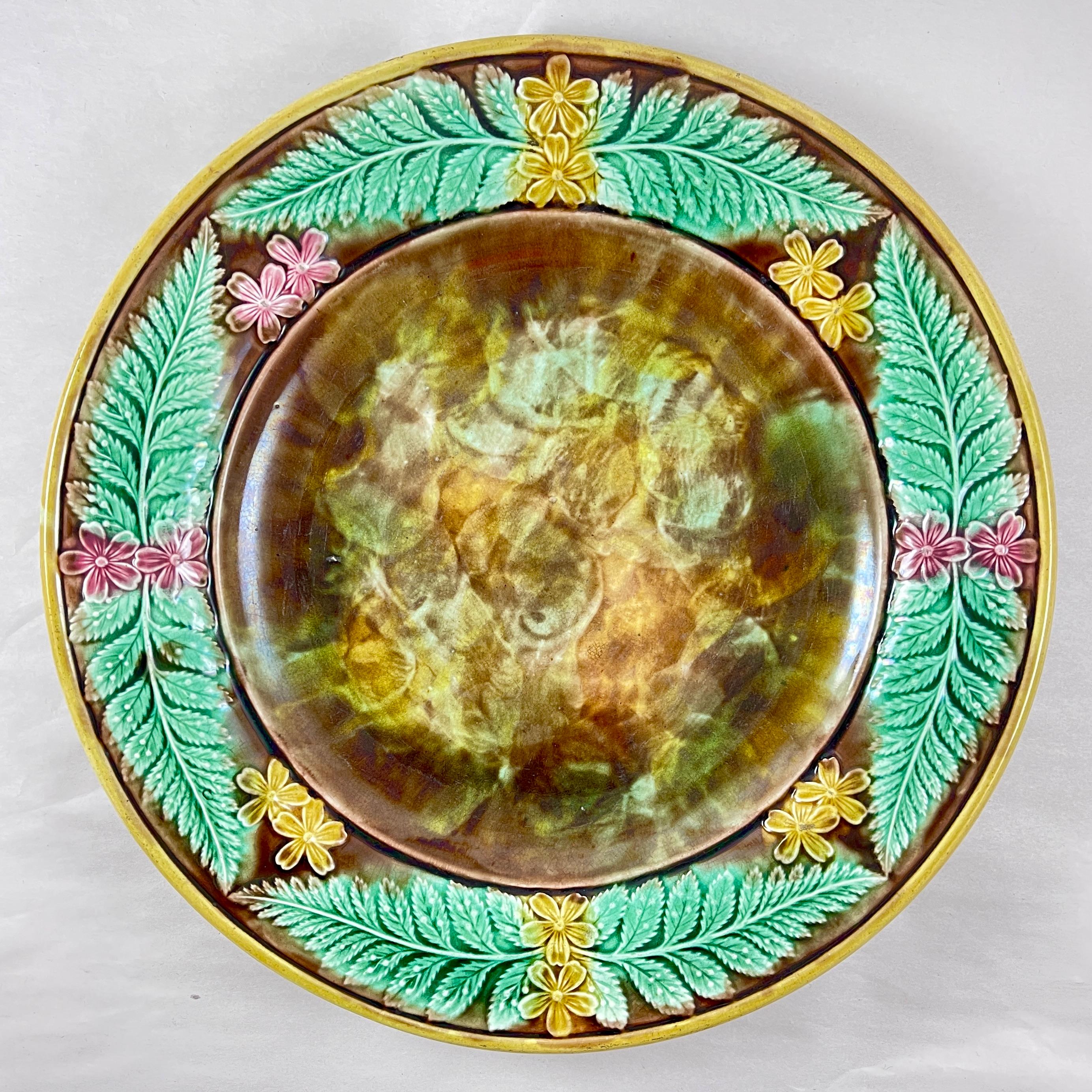 A large, round Adams & Bromley English Majolica cheese tray, late 19th Century.

Adams & Bromley operated the Victoria Works in Broad Street, Hanley, Stoke-on-Trent from 1873 to 1886.

The server shows a running border of yellow and pink butter cup