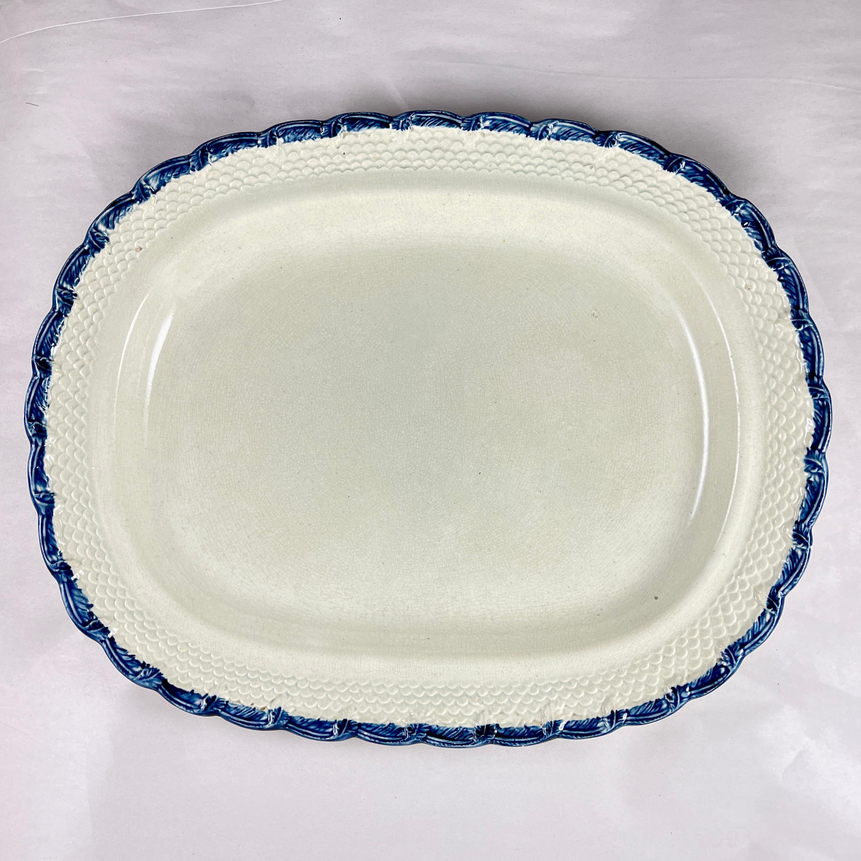 A Pearlware or Creamware Feather and Scale edged platter, William Adams & Sons, England, circa 1820-1830.

William Adams & Sons Potters Ltd. manufactured their earthenwares in Tunstall, Stoke-on-Trent, in the Staffordshire region of England,