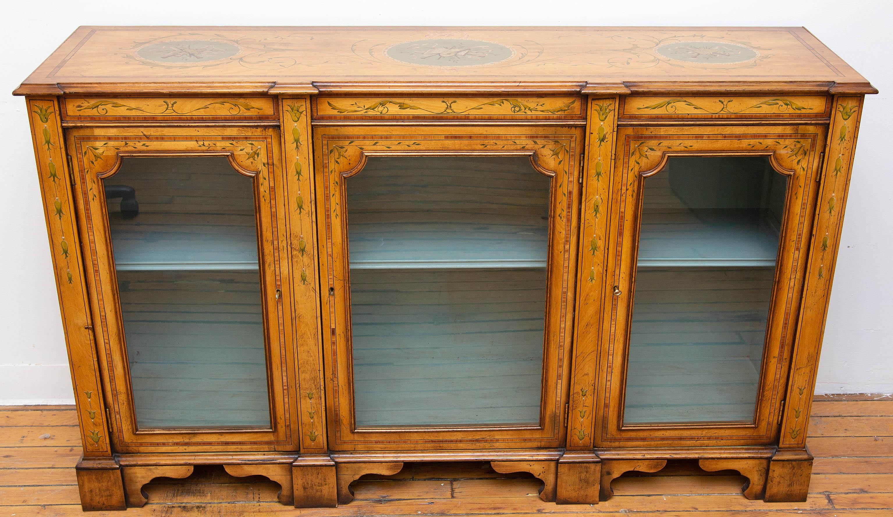 Adams style credenza vitrine. Hand painted fruitwood. With banding inlay. One shelf in each section. Interior is painted slate blue, but may be painted any color, circa 1940s. Please, contact us for shipping options.
Presented by Joseph Dasta