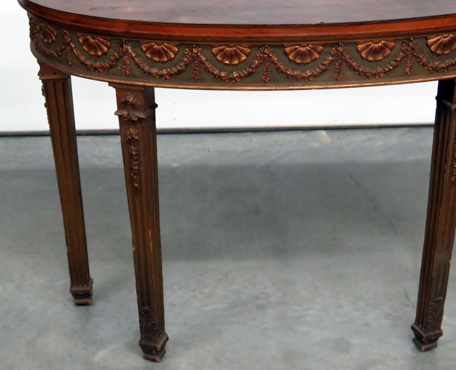 Adams style distressed finished demilune console table with gilt accents.
