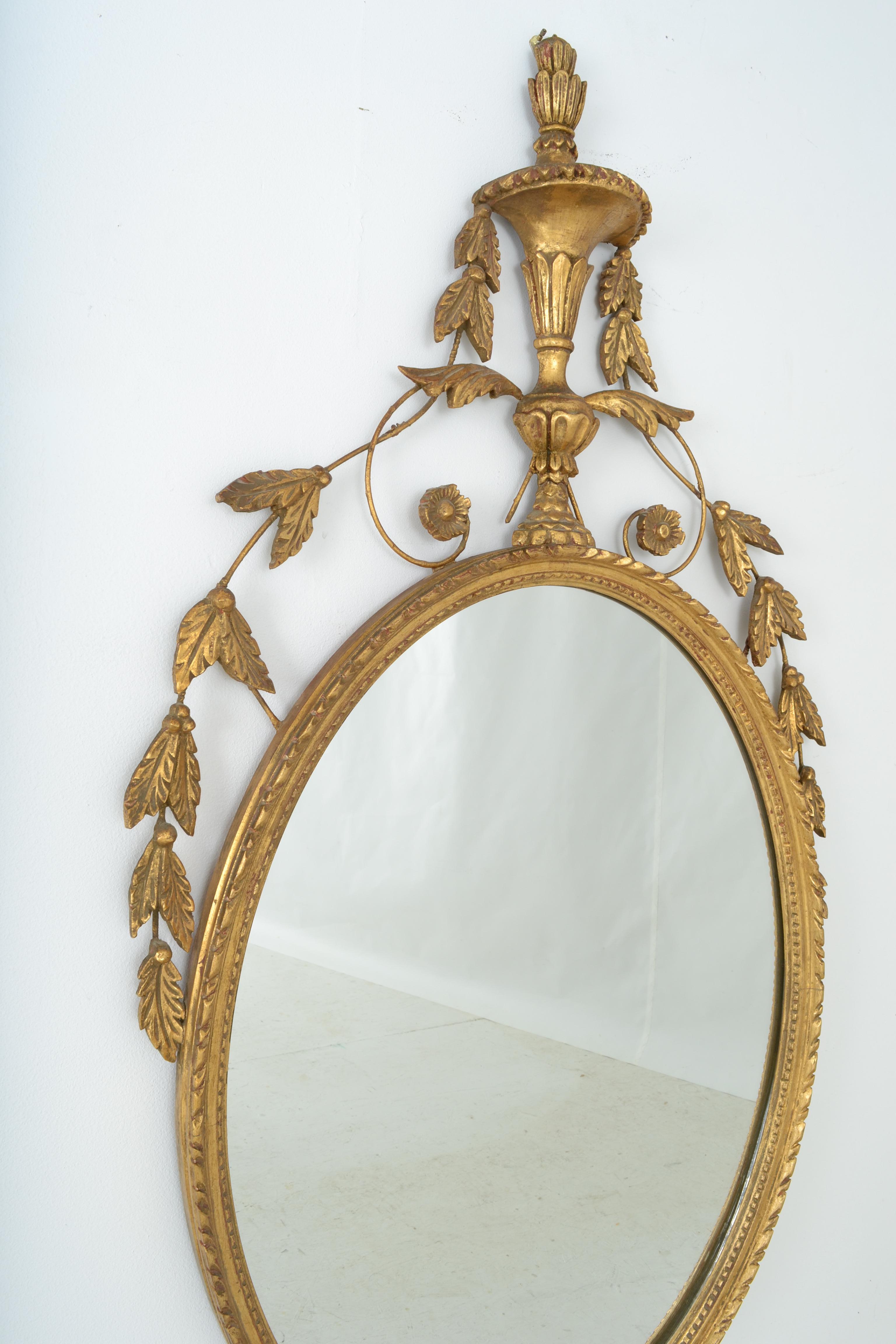 A fine quality mirror featuring hand carved giltwood. Very fine condition showing almost no wear. No chips or scratches.