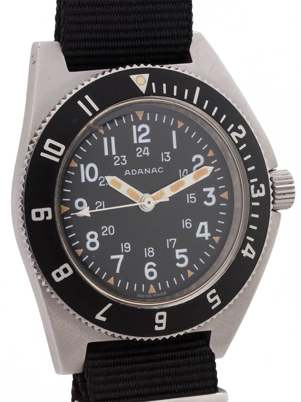
Adanac (Canada spelled backward) military issued model to the USAF and Canadian armed forces circa 1986. Featuring large 43.8 X 47.8 rugged brushed finish stainless steel case with sloped and integrated rotating elapsed time bezel, and asymmetrical