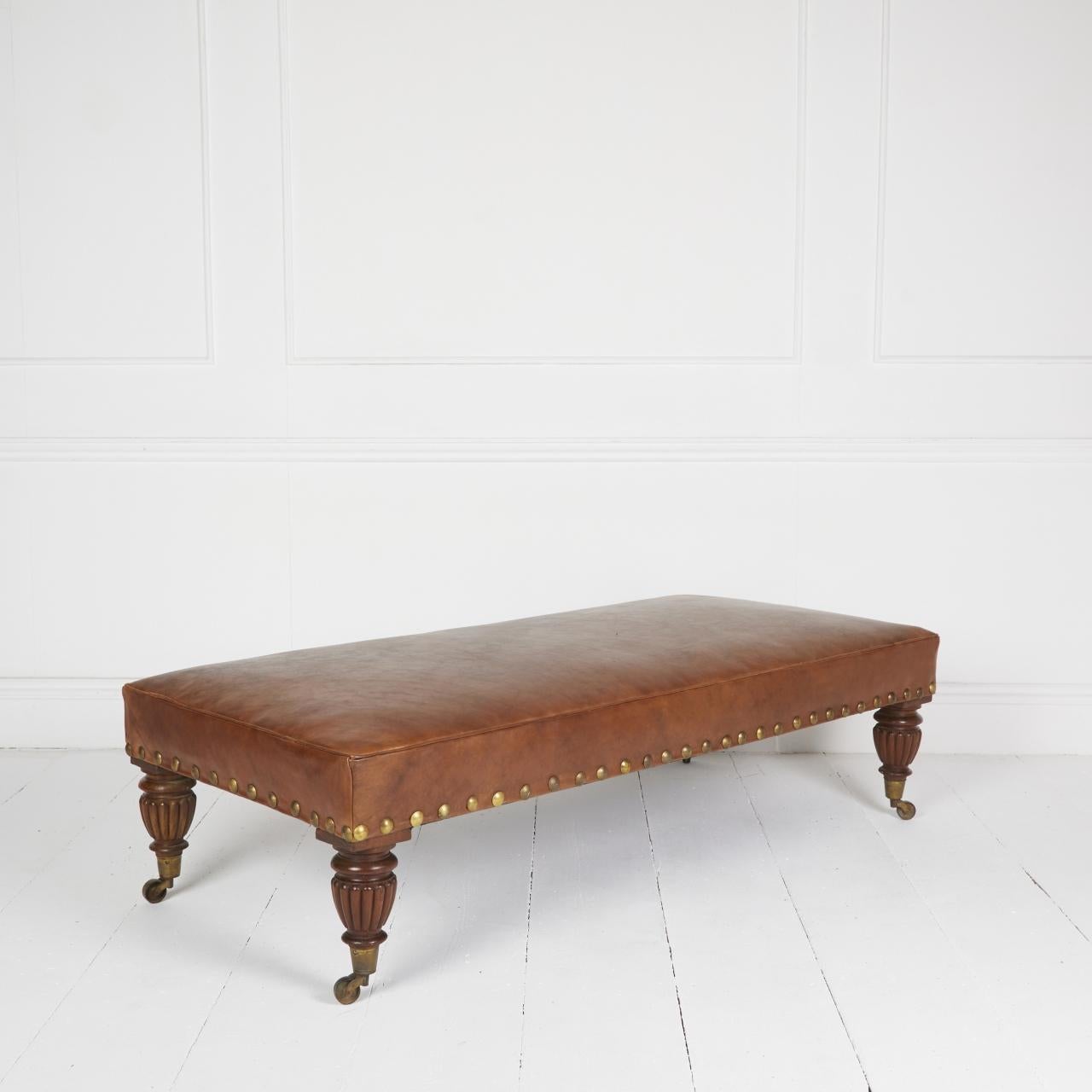 Adapted antique English daybed stool covered in hand-antiqued Italian hide with vintage brass studs standing on English Walnut reeded legs and brass castors.

Mainland delivery FOC International POA US 14 day

Dimensions: H 16″  W 60″ D 28″

Ref