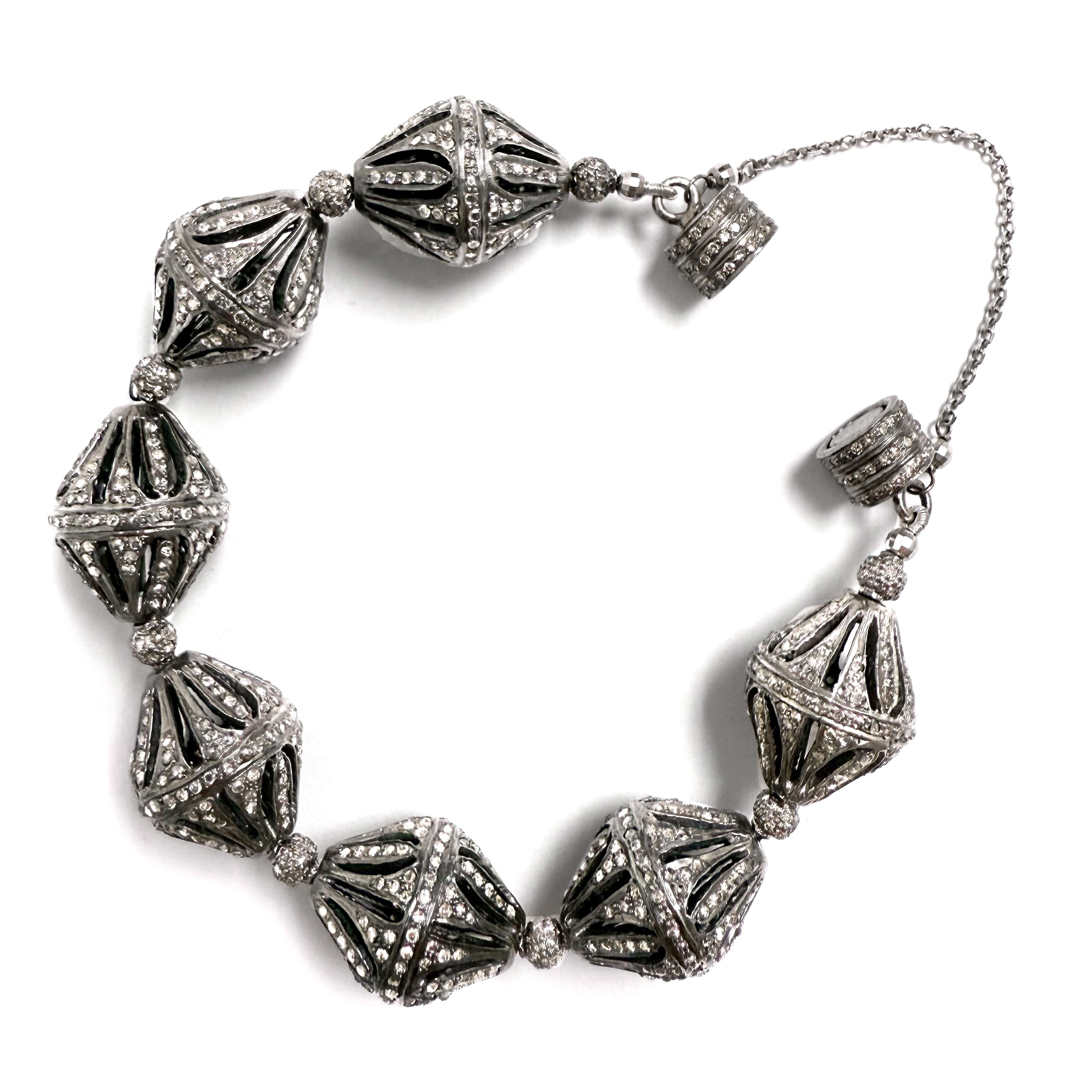 Description
This bracelet showcases seven carats of intricately crafted large fancy-shaped diamond beads.
Designed for both beauty and ease, its strong magnetic clasp offers effortless wear, elegantly secured by a delicate 14k white gold safety