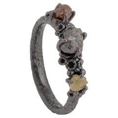 A.deitiy ring made with recycled silver, mined diamonds & black rhodium plating