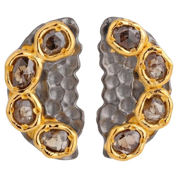 A.deitiy studs made with recycled sterling silver,  18k gold plating and diamond