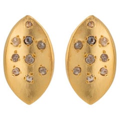 A.deitiy studs made with recycled sterling silver,  18k gold plating and diamond