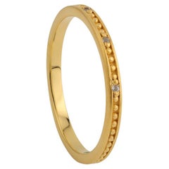 A.deitiy thin band made with recycled silver, and 18k gold plating