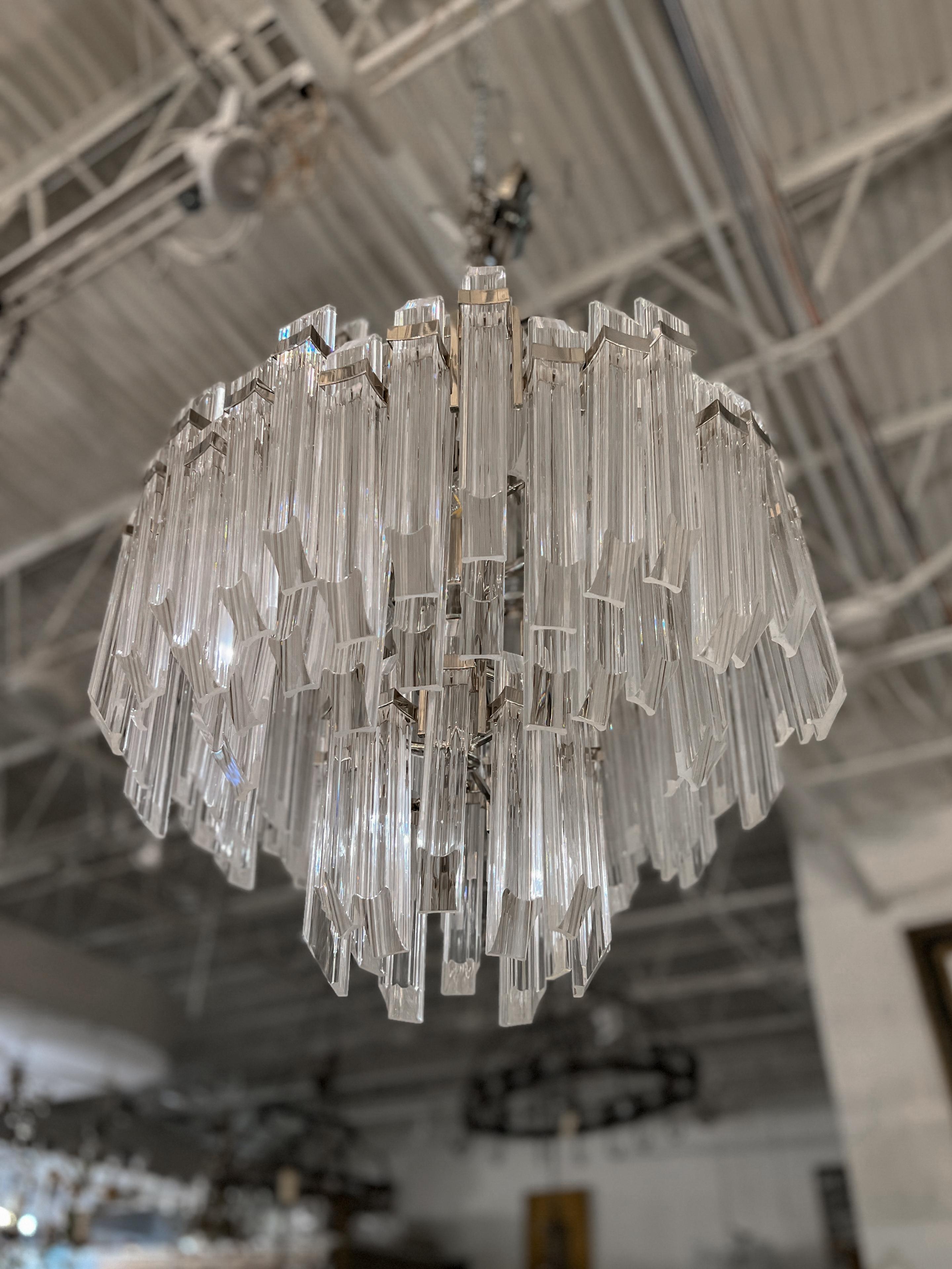 The Adele four tier waterfall chandelier by Suzanne Kasler harps back to the beautiful Art Deco era where glamour and detail was king. This piece is absolutely stunning and remains in excellent condition. The wiring remains in tact and will