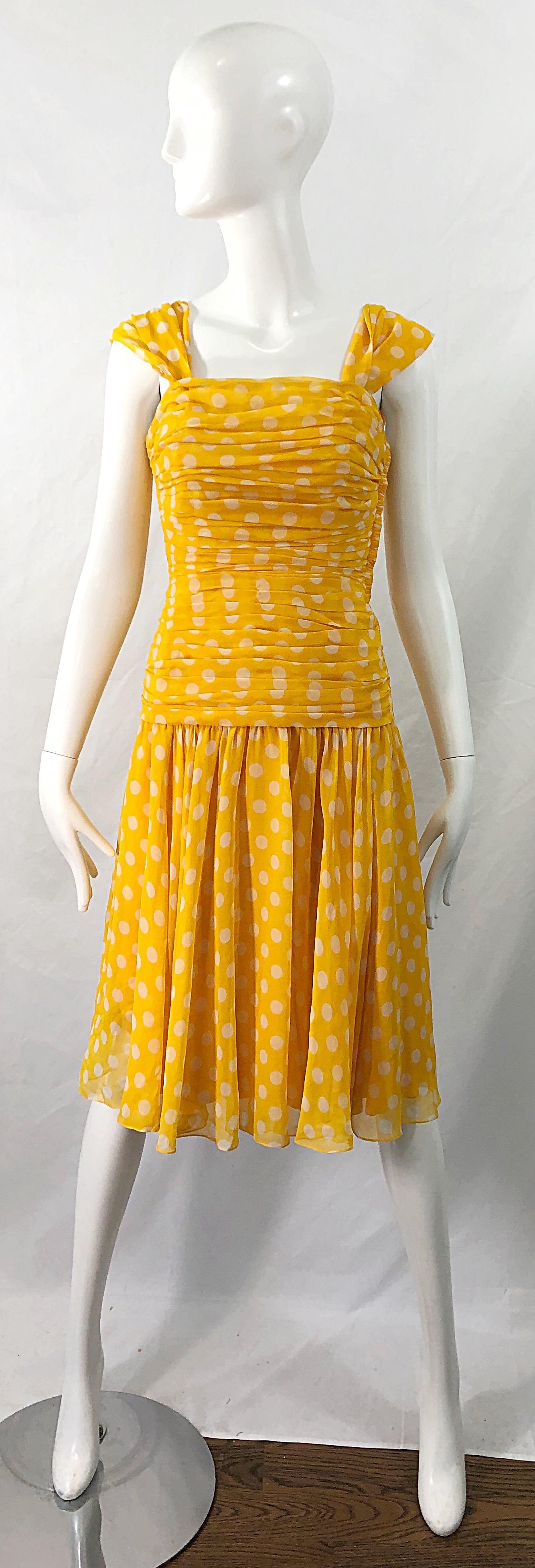 Flirty 1980s ADELE SIMPSON yellow and white silk chiffon polka dot dress ! Features a boned ruched bodice, with a slightly dropped waist. Multiple layers of chiffon on the skirt. Fully lined. Hidden zipper up the side with hook-and-eye closure.