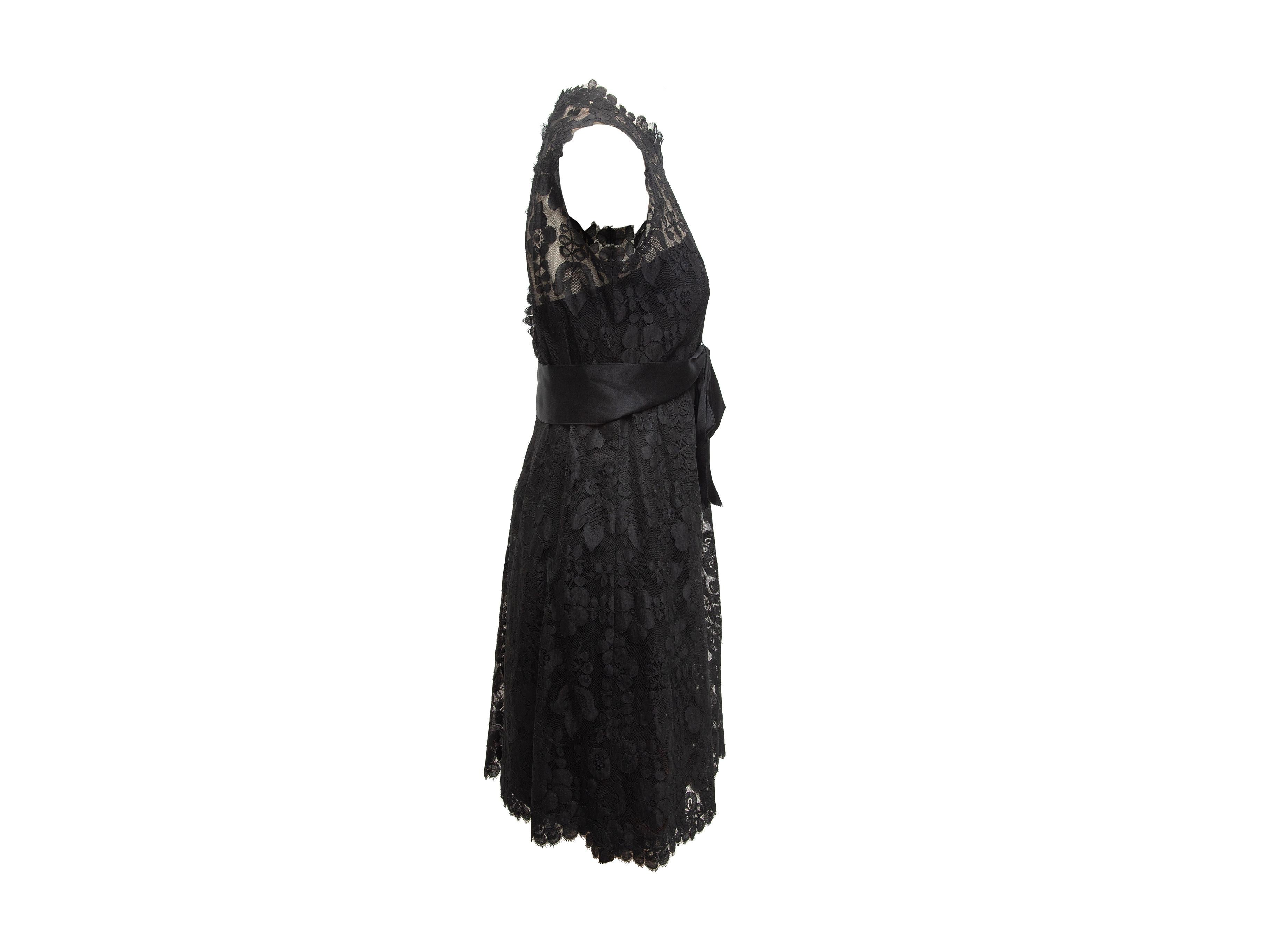 Product details: Vintage black lace sleeveless dress by Adele Simpson. Crew neck. Partially sheer bodice. Satin bow at waist. 32