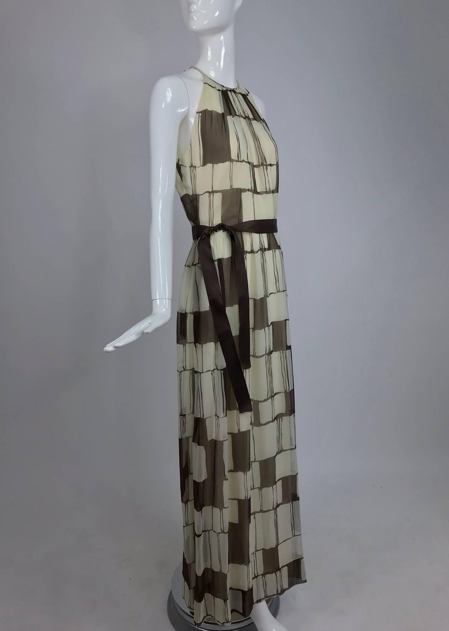 Adele Simpson brown and white silk chiffon halter maxi dress from the 1970s...Brown and white colour blocks create this bold pattern fabric...Halter neck dress shows lots of bare shoulder, it is has deep arm openings...Seamed waist with lightly